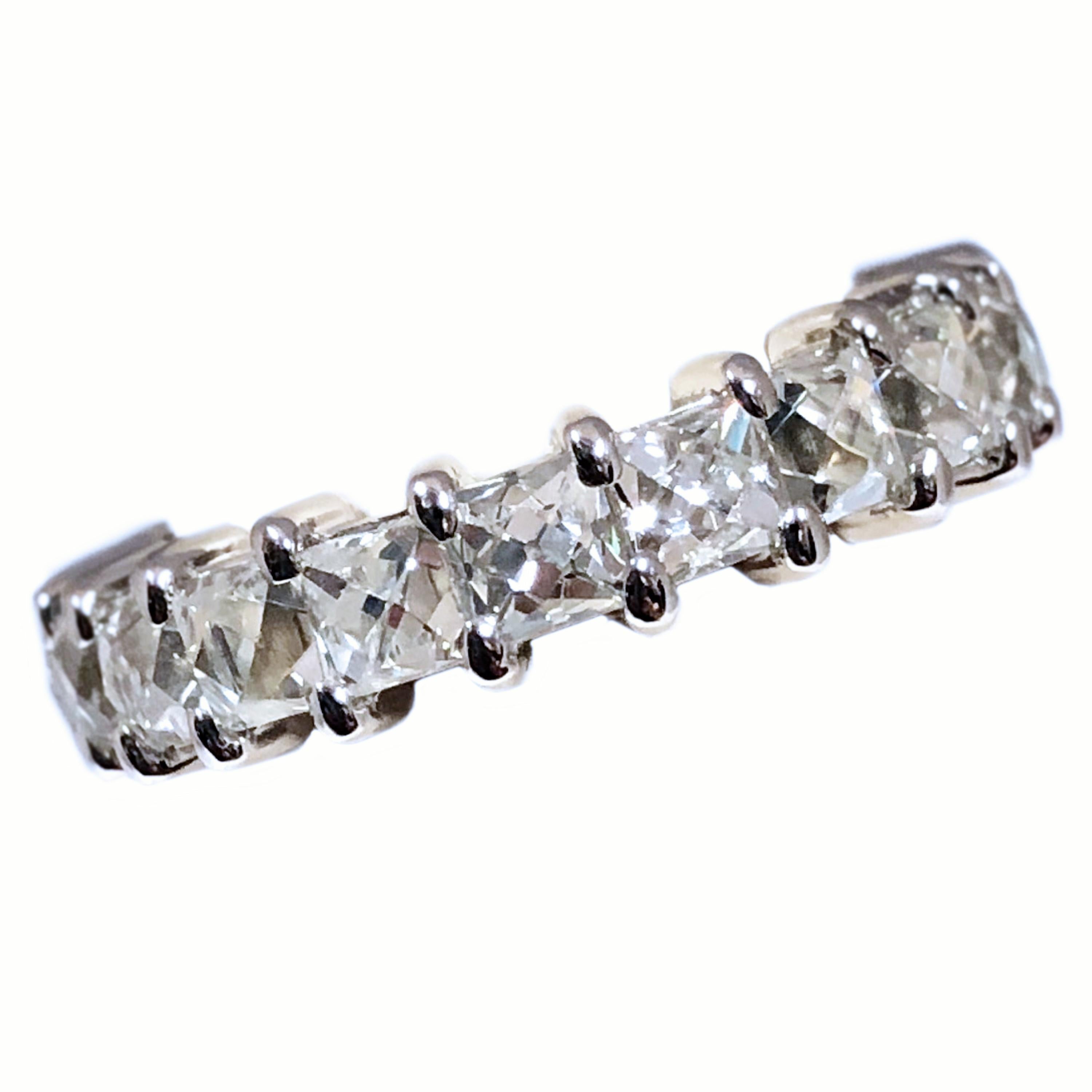 Platinum Eternity Band ring set with French cut Diamonds, each French cut Diamond measures 3 X 3 MM with a total of 20 stones set in this band totaling 5.19 Carats. The stones grade as H in color and VS in Clarity, the Ring measures 4.5 MM wide,