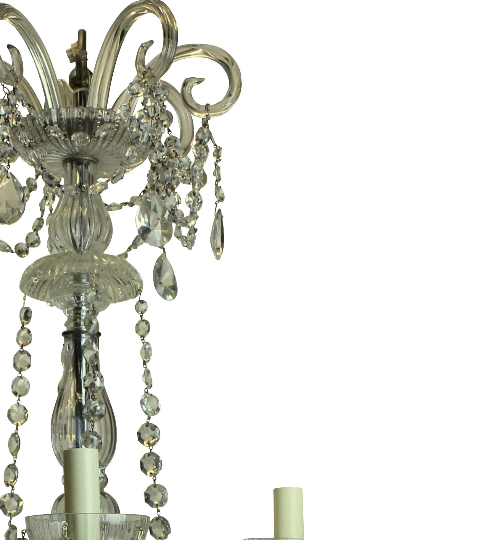 A French cut-glass chandelier of good proportions, with scrolls and swags.