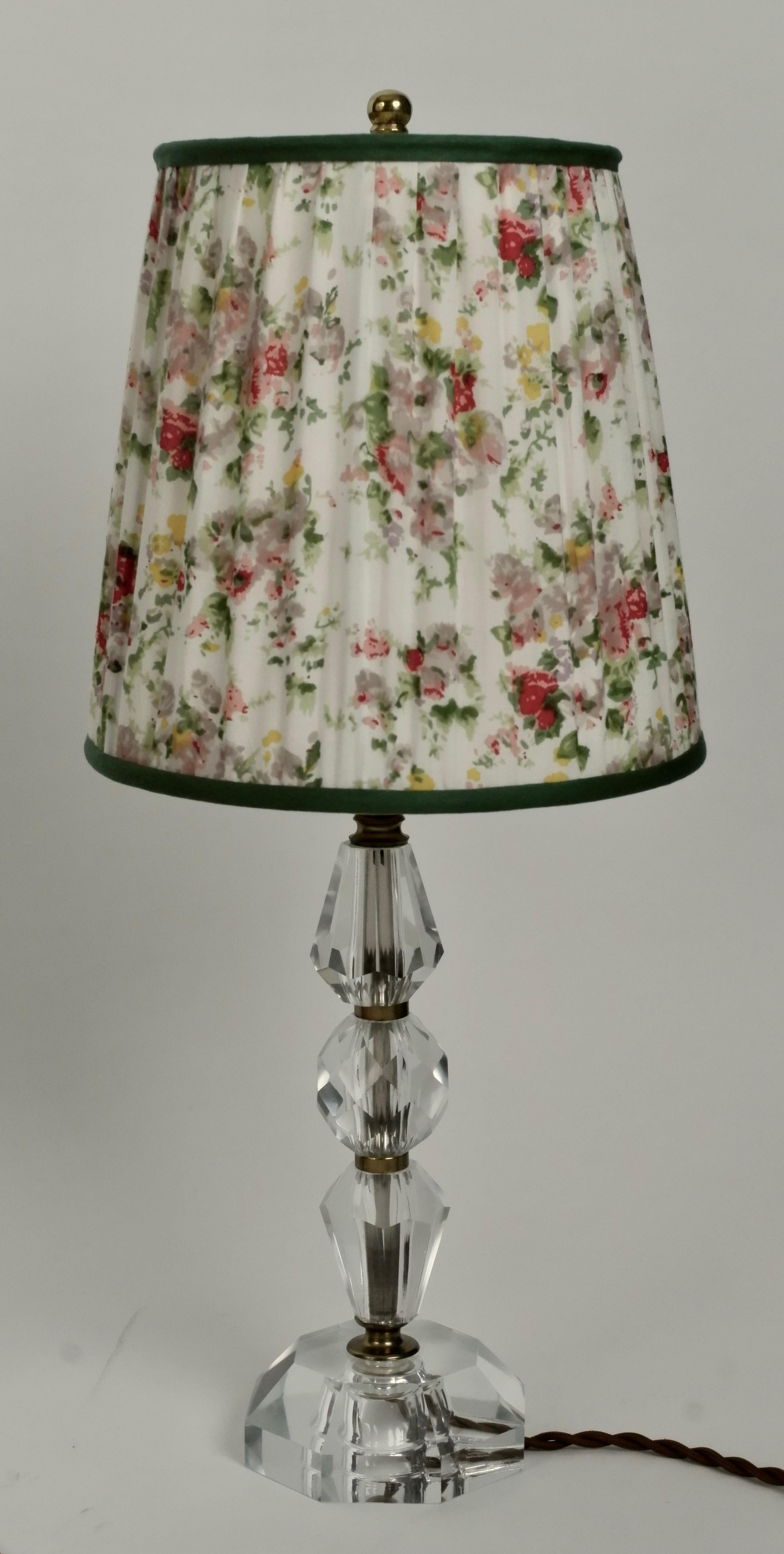 A beautiful cut glass lamp from France. The shade is covered with a vintage silk textile ,using the original frame.
The woven textile cable adds a contrast to the glass.