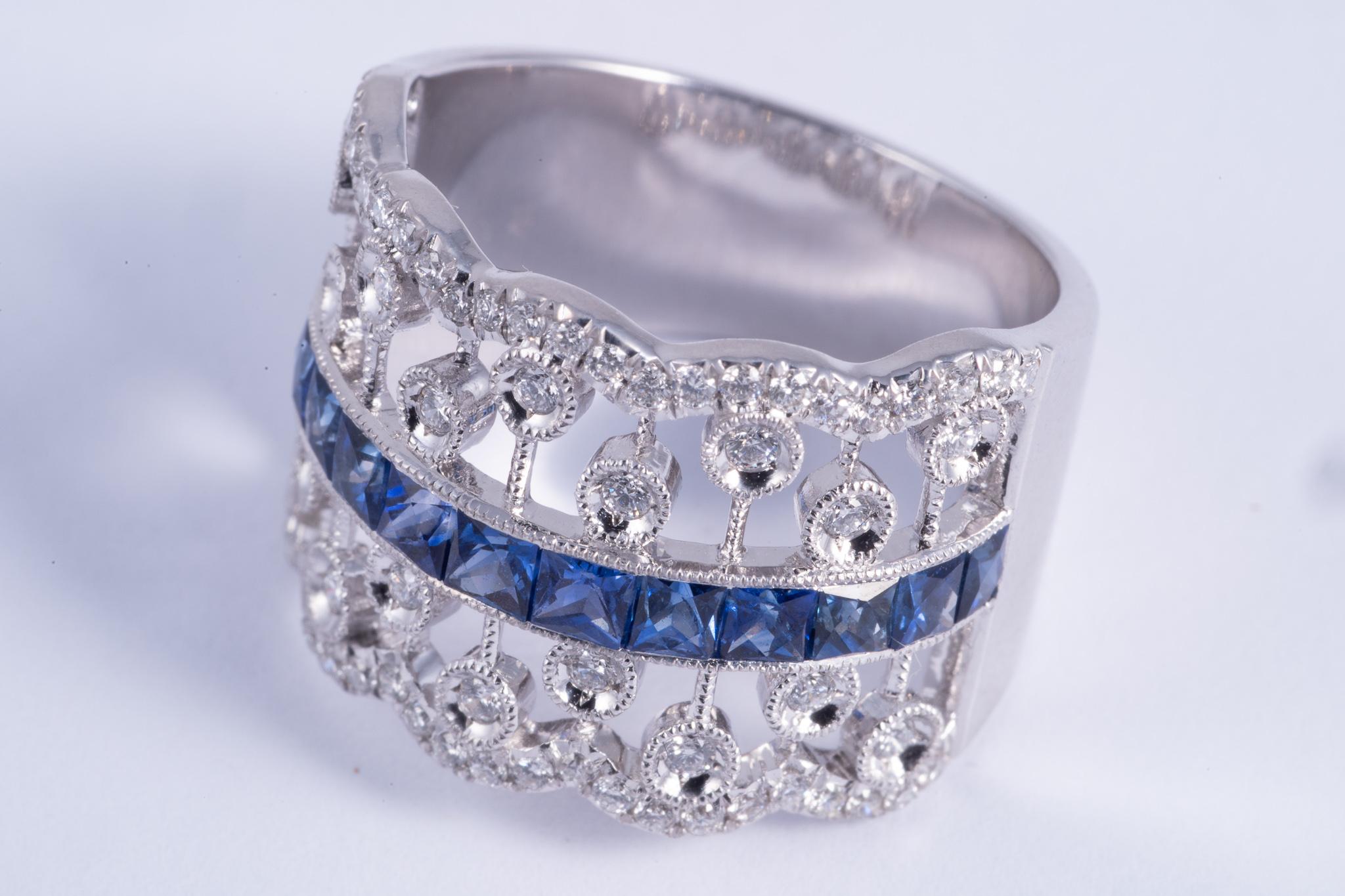 This very beautiful ring features french cut blue sapphires. The sapphires weigh 1.46cts total. The accent diamonds have G-H color and SI1 clarity. The ring is set in 14k white gold. the gold weighs 7.80grams. It is a size 6.75 and can be sized.