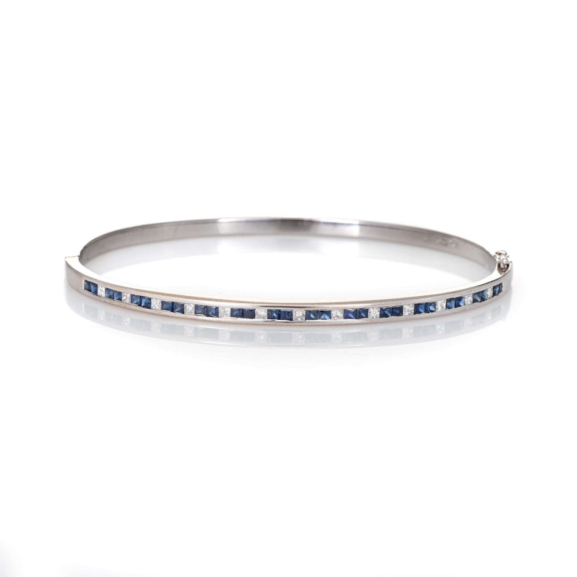 Finely detailed estate sapphire & diamond bangle bracelet crafted in 18k white gold. 

28 French cut sapphires are estimated at 0.02 carats each and total an estimated 0.56 carats. 13 estimated 0.02 carat princess cut diamonds total an estimated