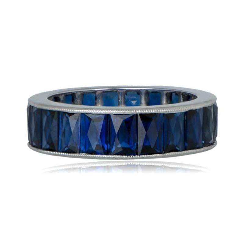 A stunning wedding band featuring elongated French Cut Sapphires set in platinum. The sapphires are delicately channel-set within the polished band, showcasing timeless elegance. Fine milgrain detailing enhances the overall delicacy of this