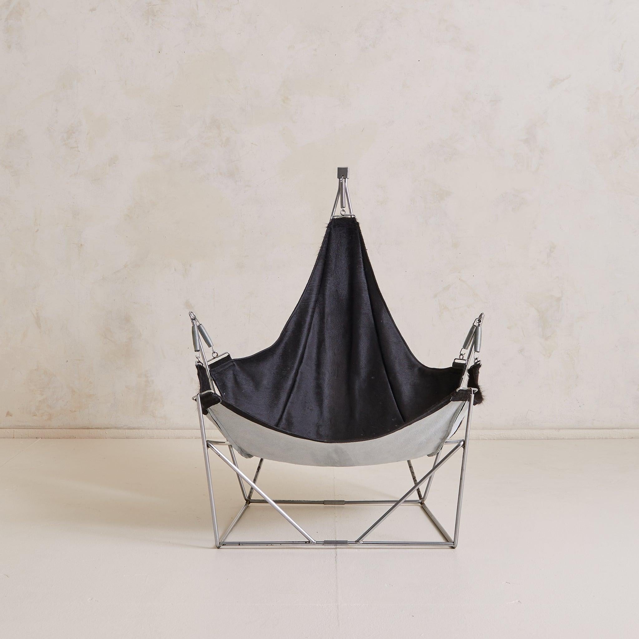 The ‘David’ lounge chair, designed by Odile Mir and produced by Delmas for Prisunic in 1972, is as much architecture as it is seating. Its chromed steel frame is crafted to suspend a sling of black cowhide, stretched taut with industrial springs and