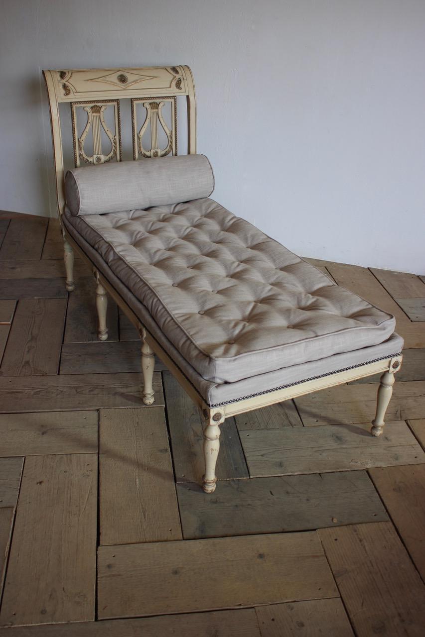 A circa 1900 French painted daybed in the Directoire taste, retaining the original paint and having been reupholstered in a neutral fabric.
Measures: Floor to seat 45cm height.