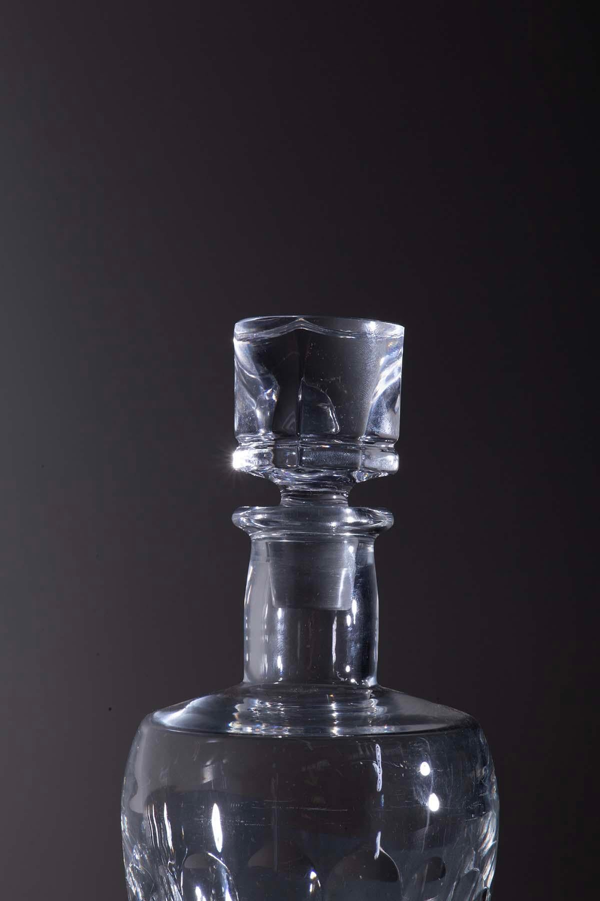 This beautiful decanter is an authentic creation of French craftsmanship from the 1970s, originating from a private Milanese home. Crafted from fine Baccarat crystal, it represents the epitome of sophistication. Baccarat crystal is renowned for its