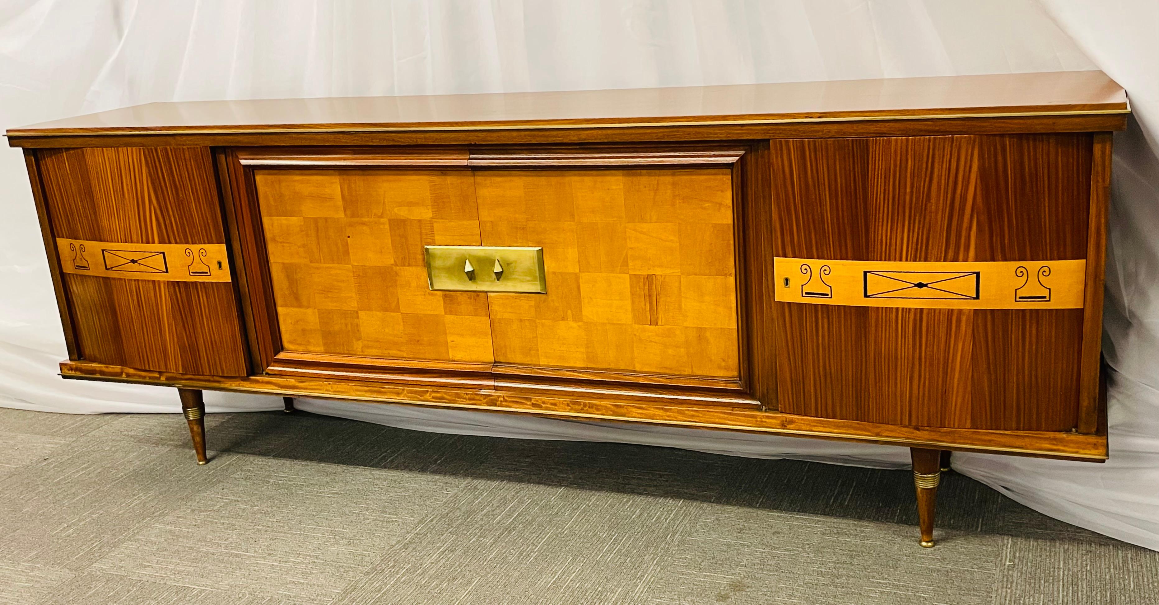 A French Art Deco Macassar sideboard. This large and impressive sideboard server cabinet has bronze mounts on the top and bottom as well as bronze double leg caps. The interior fully fitted with shelves on the right had side and fitted silverware