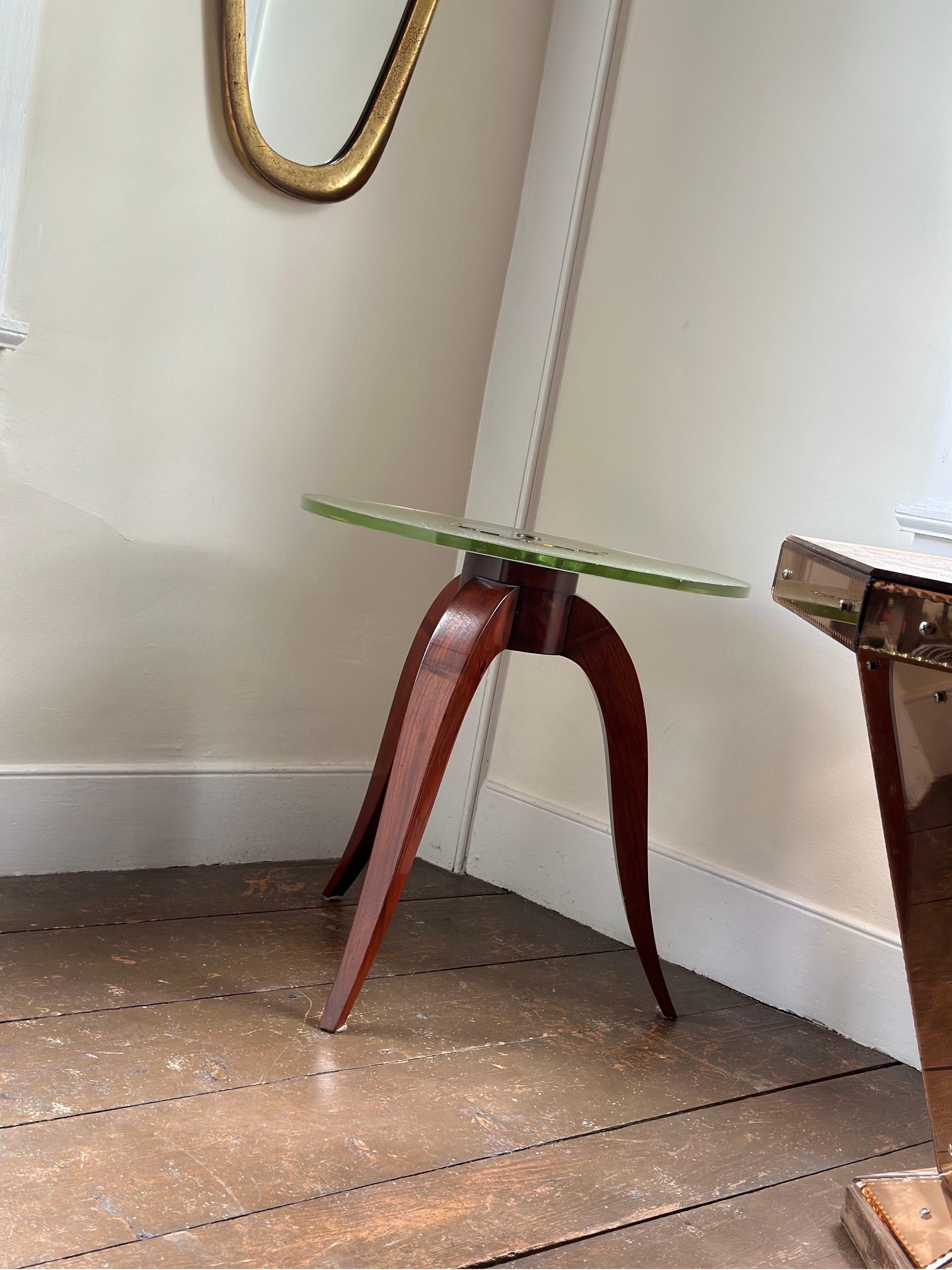 This is a unique French Art Deco side table with textured glass and patinated  bronze center detail.  The top sits on three curved polished mahogany legs. No nicks or scratches in the glass, overall in excellent condition.  