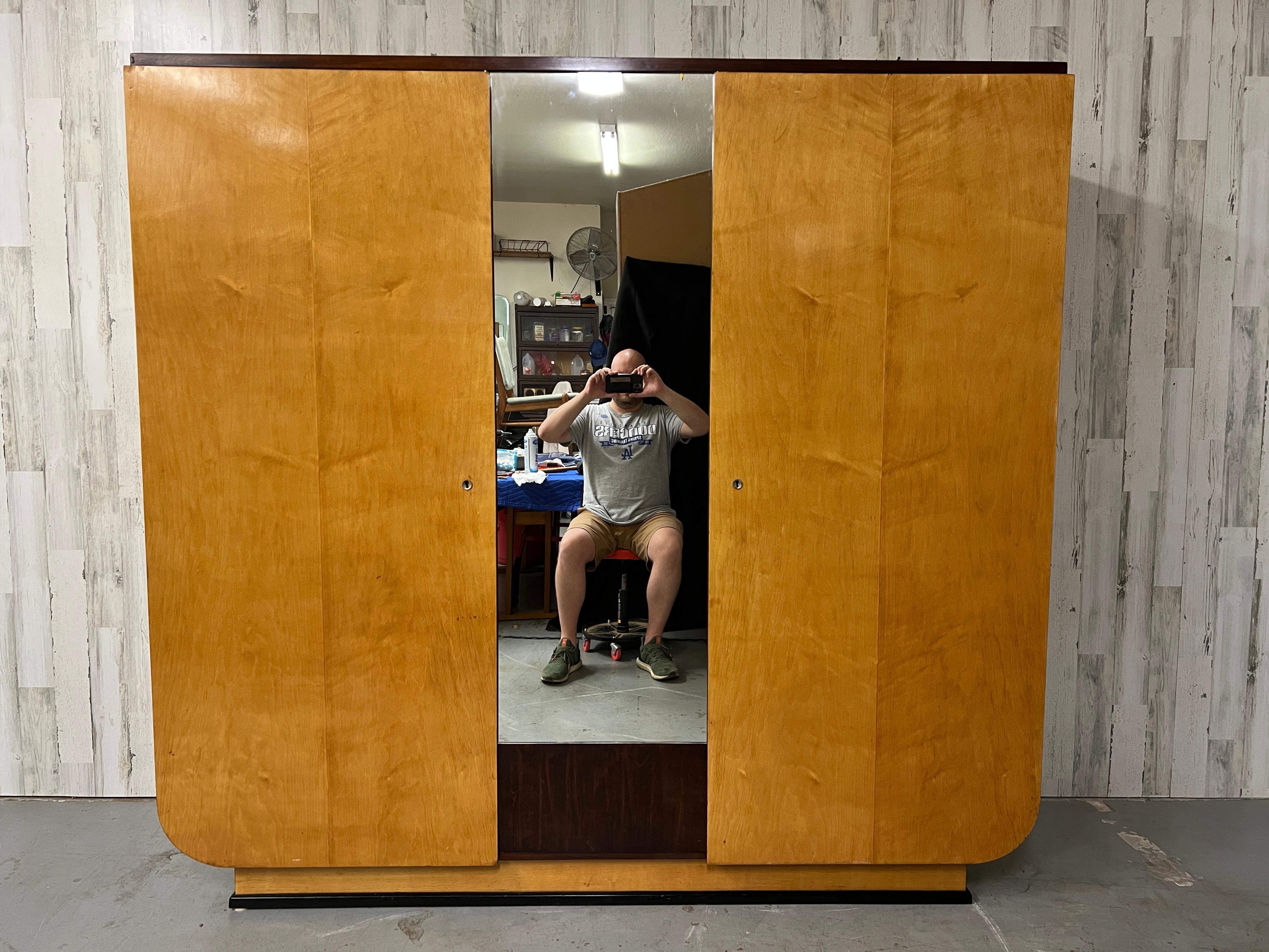 French Art Deco Sycamore three door Wardrobe. Storage on both sides for hanging clothing. 
Inside left door measures: 21.25 D x 28 W 
Inside right door measures: 21.25 D x 49.5 W.