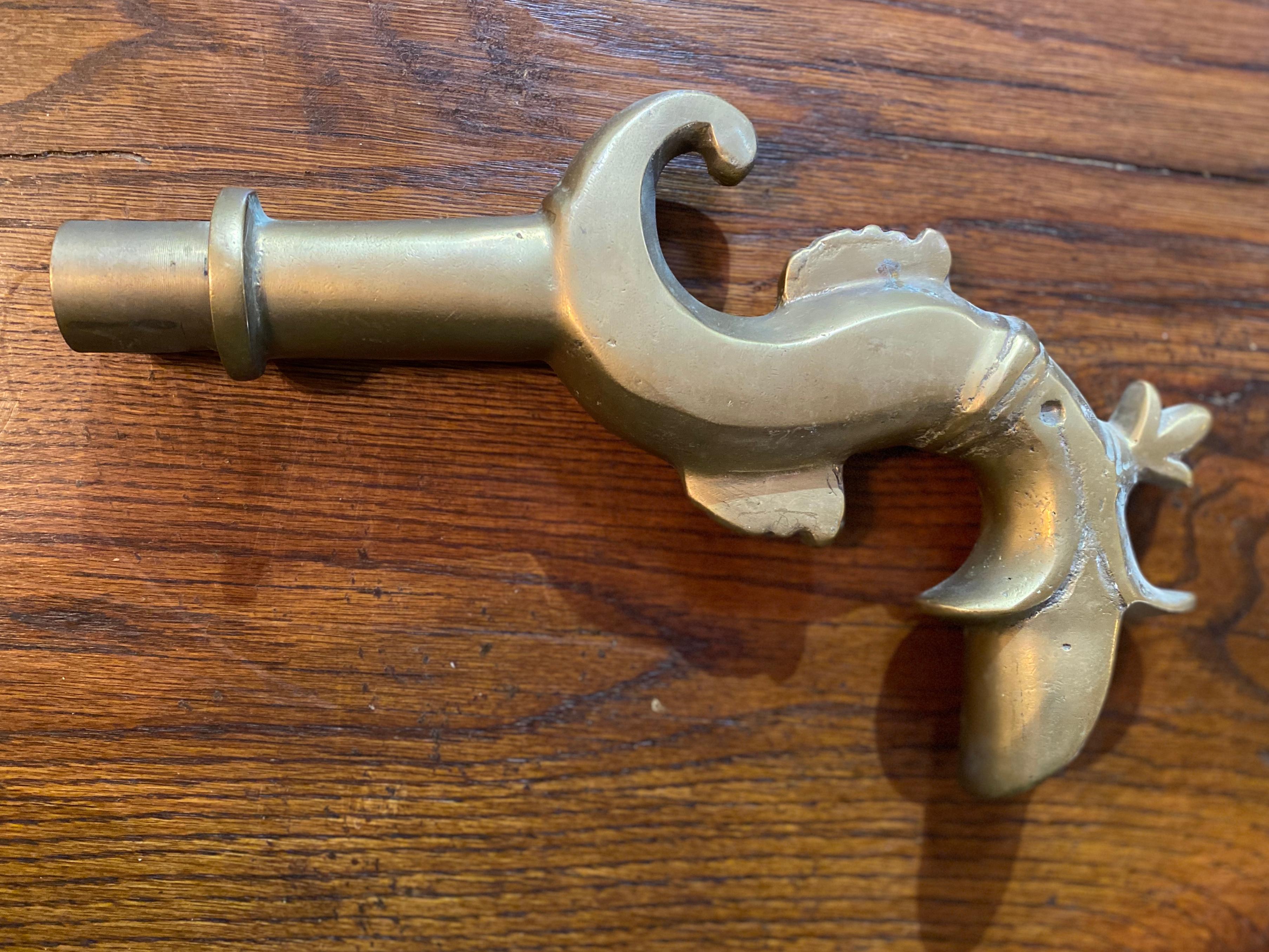 This spout is made of heavy brass and made in a decorative style to add character to your garden fountain. 

Measurements: 10.5” L x 6.5” H x 1.5” W.