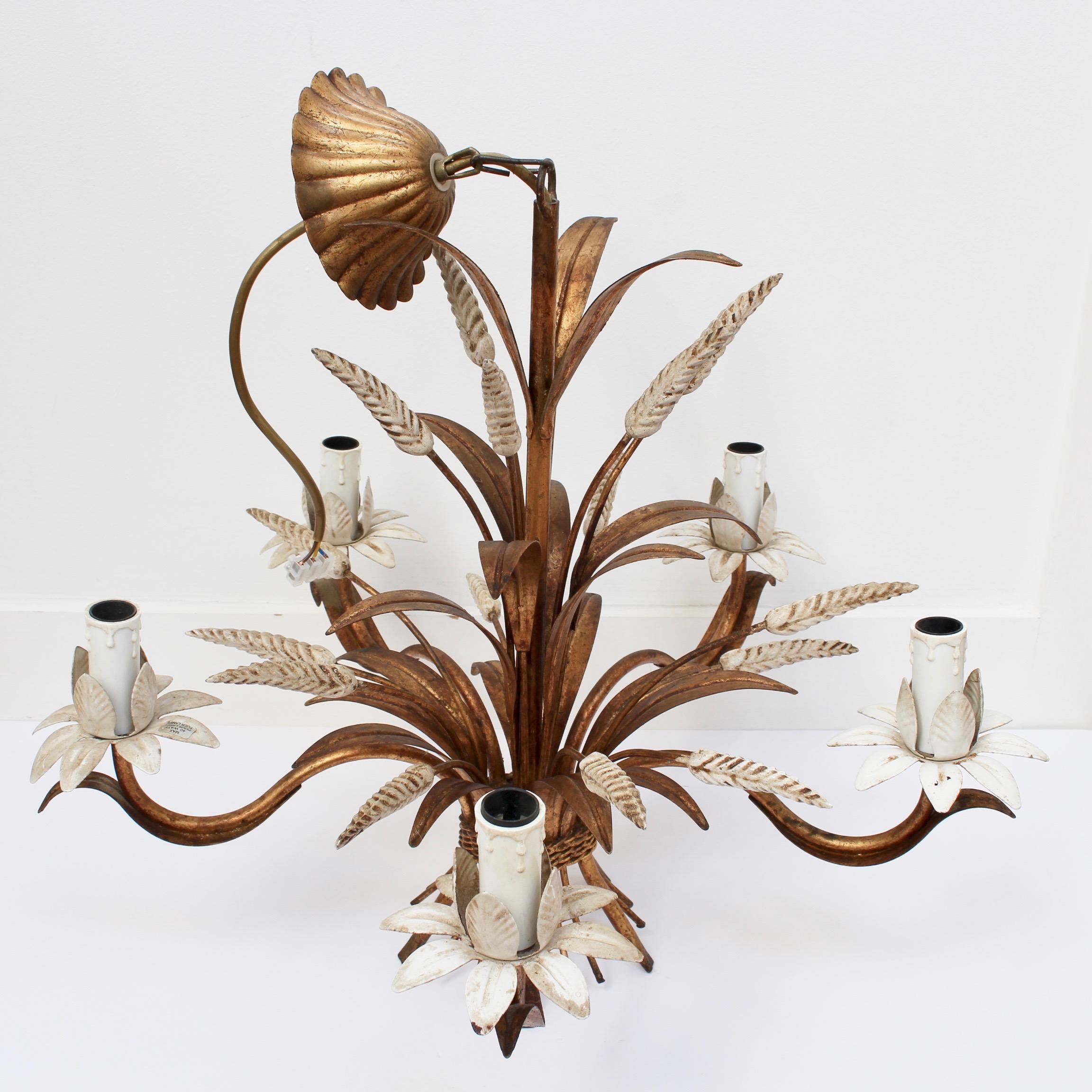 French decorative tole chandelier (circa 1960s). A classic wheat sheaf-shaped lighting fixture with five branches extending to ornamental bulb holders, each with a surround of leaves. Near the top of the piece, a flower-shaped cover connects the