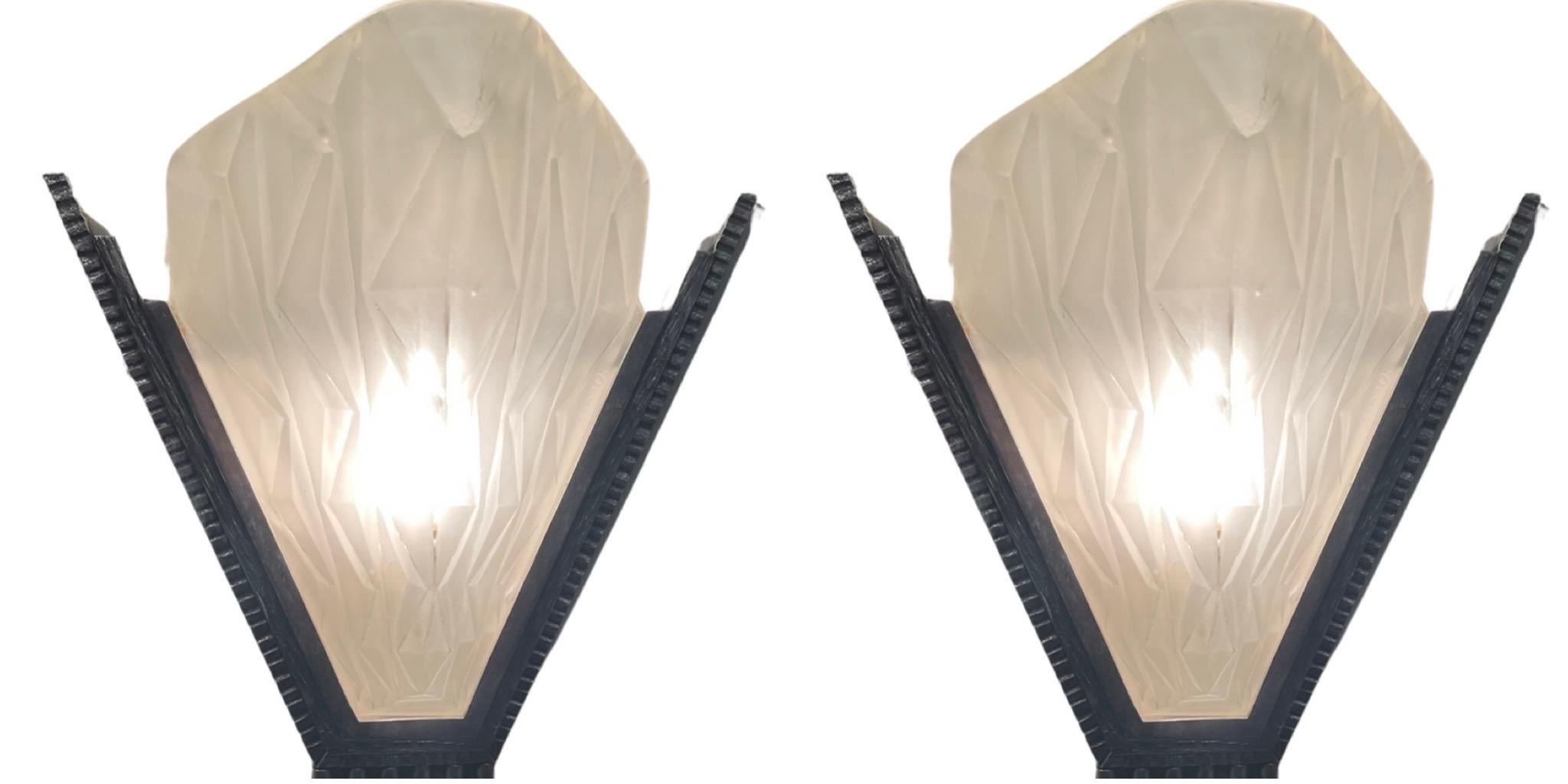 A pair of French Art Deco wall sconces by the French artist ” Degue ” in molded clear frosted glass decorated with geometric motifs. French Degue Art Deco Sconces With Bronze Metal Wall Supports. Geometric design with nice size and heavy nickeled