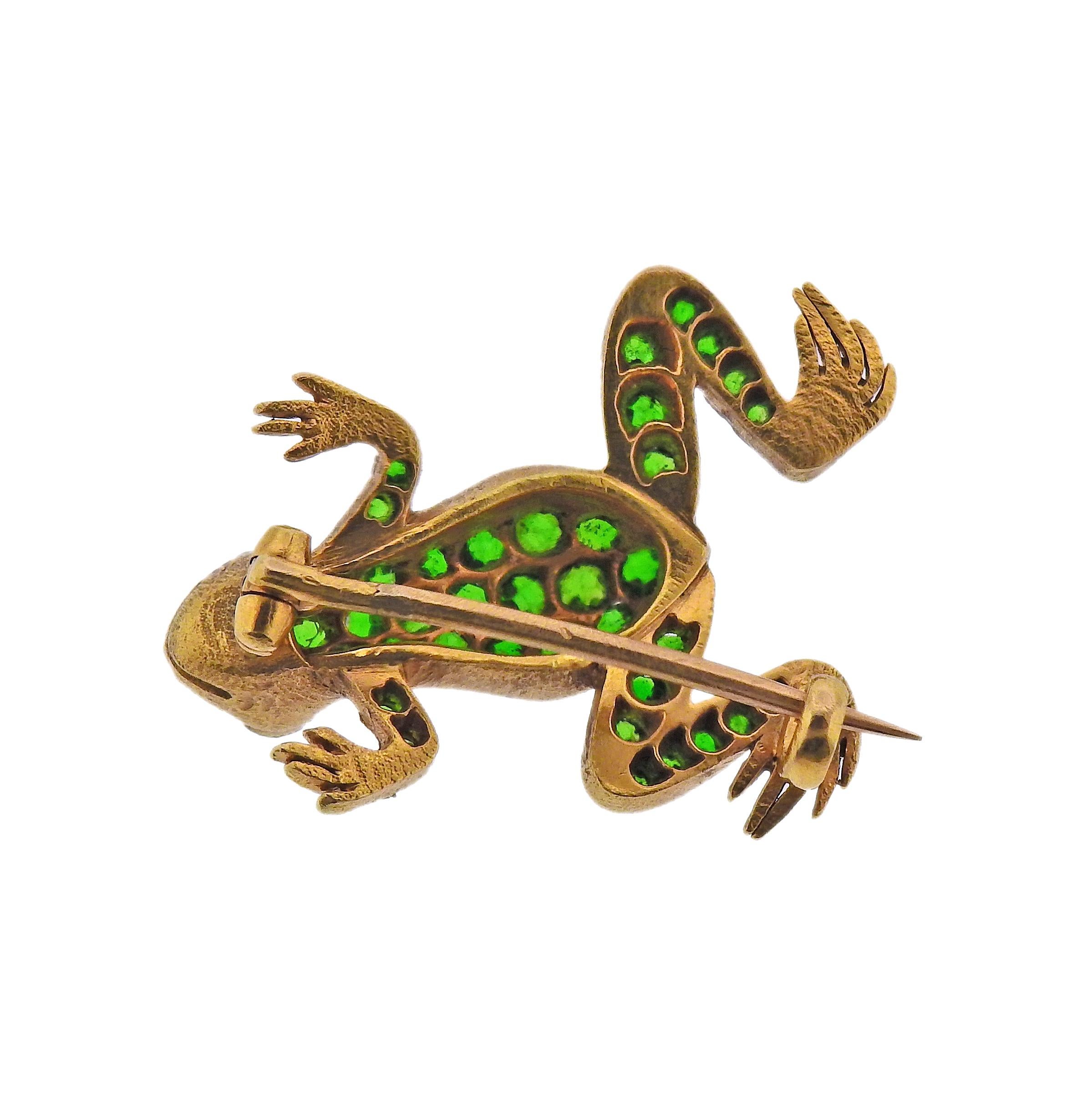 French made 18k gold frog brooch, with bright demantoid garnets and diamond eyes. Brooch measures 23mm x 20mm. Marked with Eagle head mark on the clasp. Weight - 5.8 grams. 