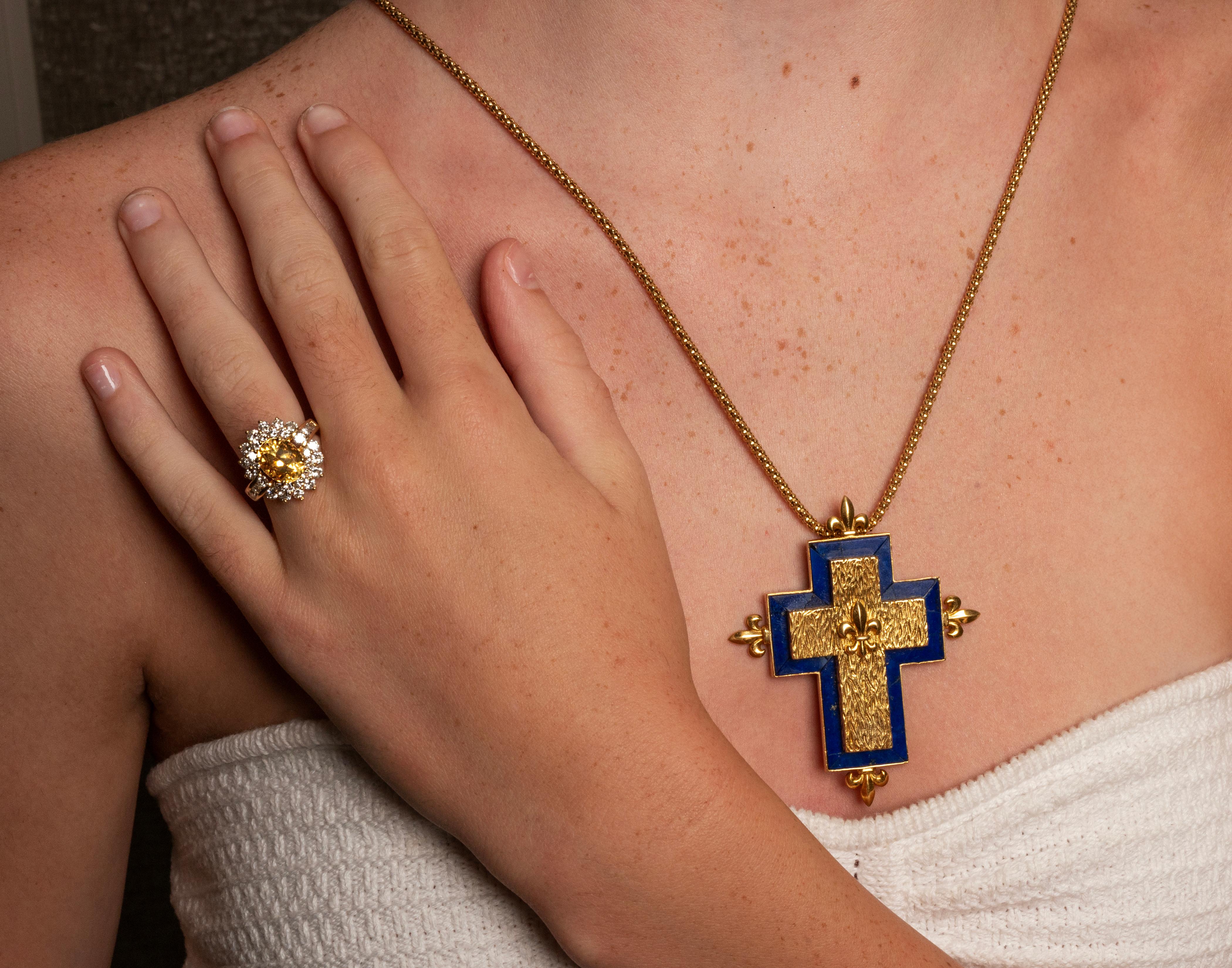 French Depose Lapis Lazuli Cross Pendant Necklace. The cross features lapis lazuli inlay in 18k gold, accented by fleur-de-lis motif. The pendant is on a 24 inch 14k yellow gold chain chain. Pendant measures approximately 2.75 x 2.25 inches, total