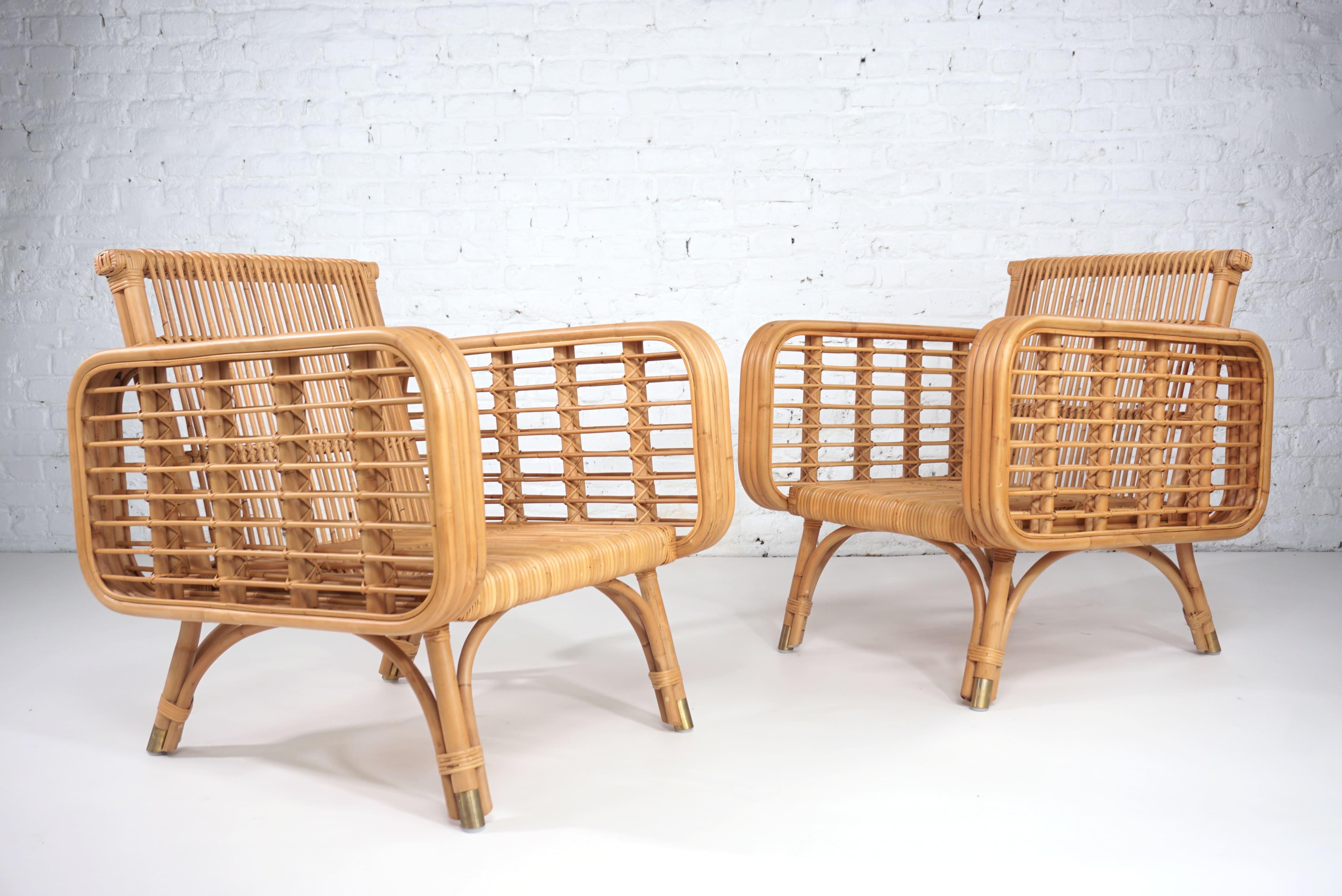 French design and 1950s style rattan and brass pair of armchairs composed of a high quality rattan and aerial structure with brass finishes. (seat and back new foam cushions include)