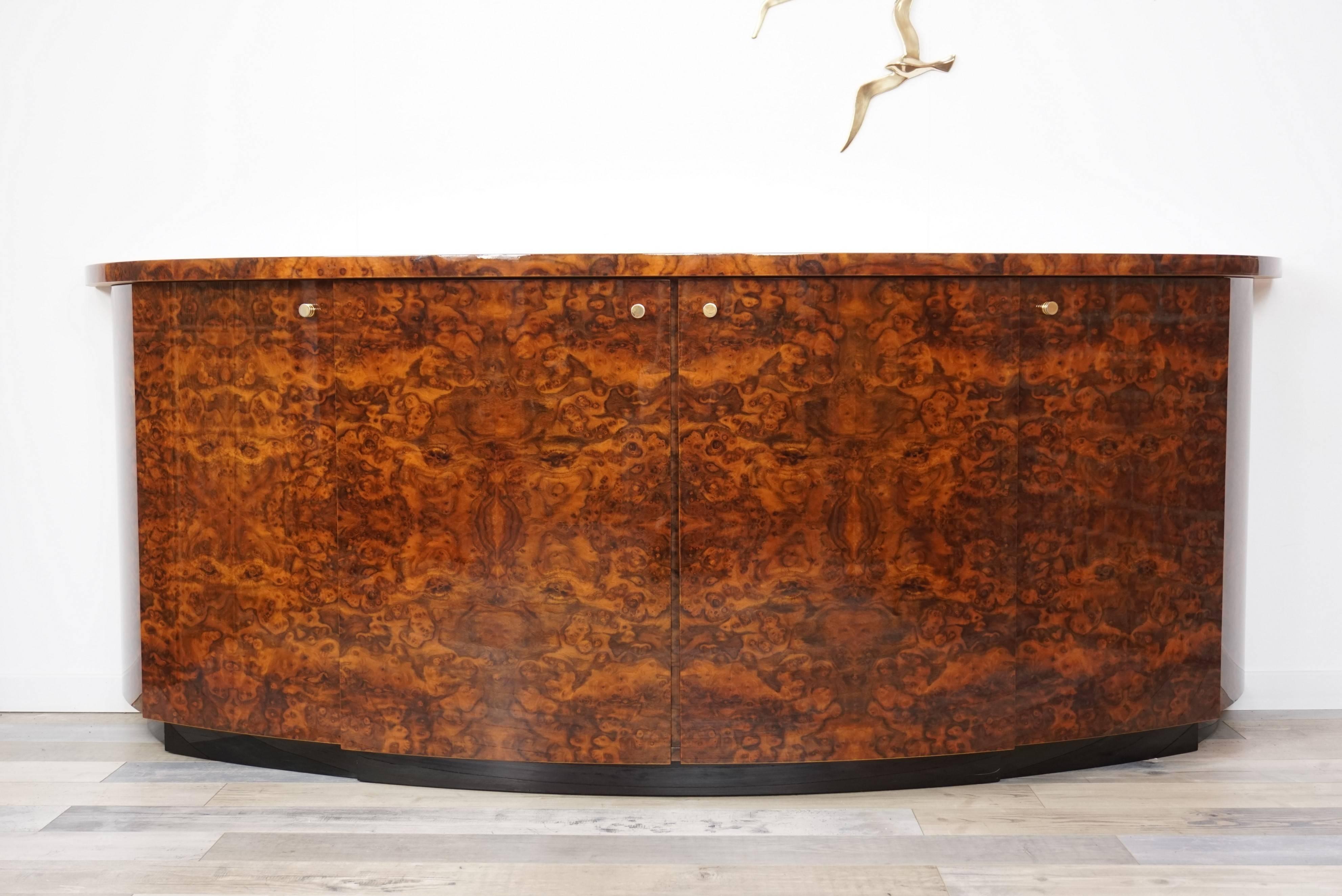 Amazing French workmanship, noble materials (lacquer, burl wood, brass) full of charm and character, lacquered burl wood structure, brass handle for this curved line and Art Deco style rare sideboard by Mahey Paris.