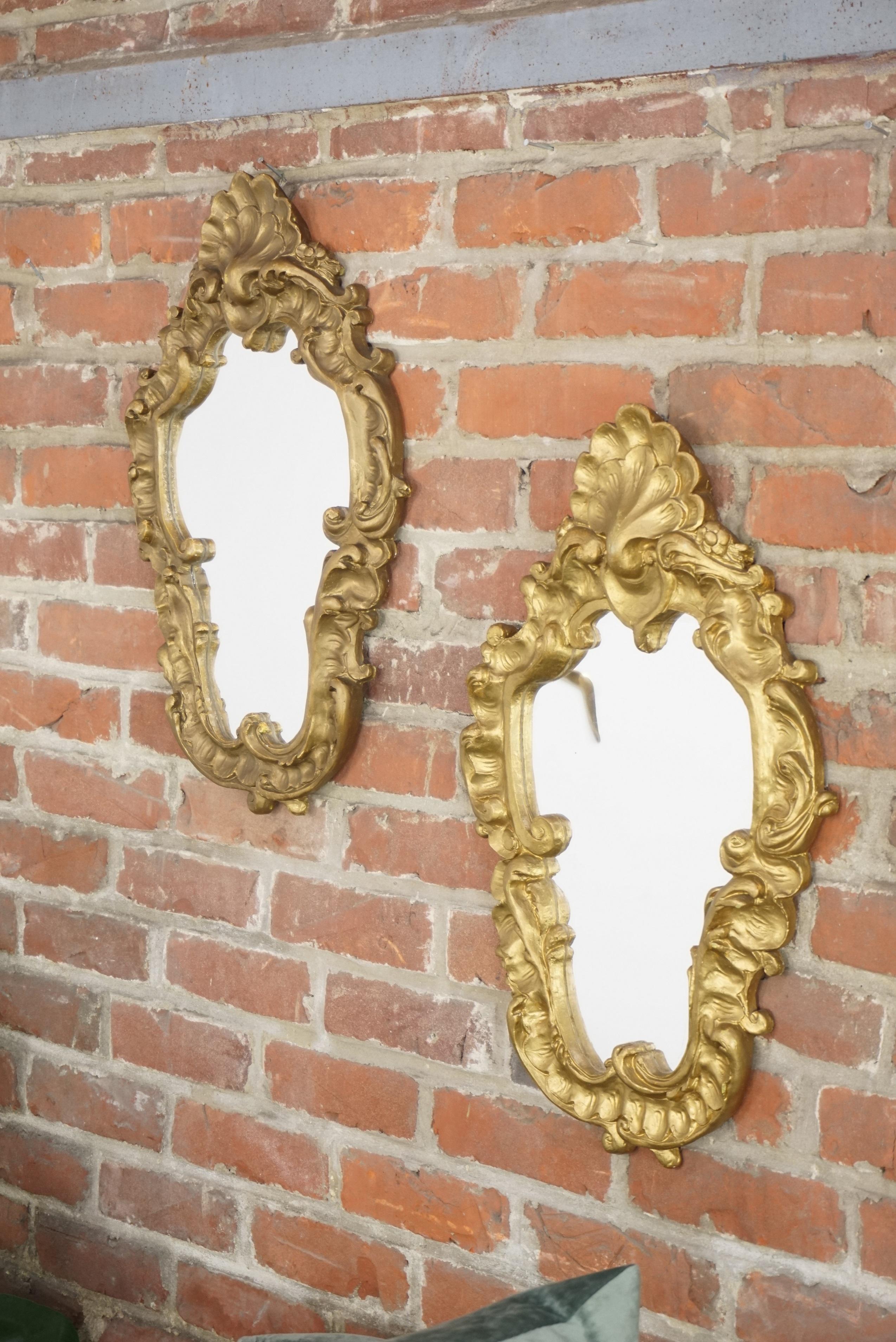 Antique Rococo style pair of mirrors in plaster and gold-plated.