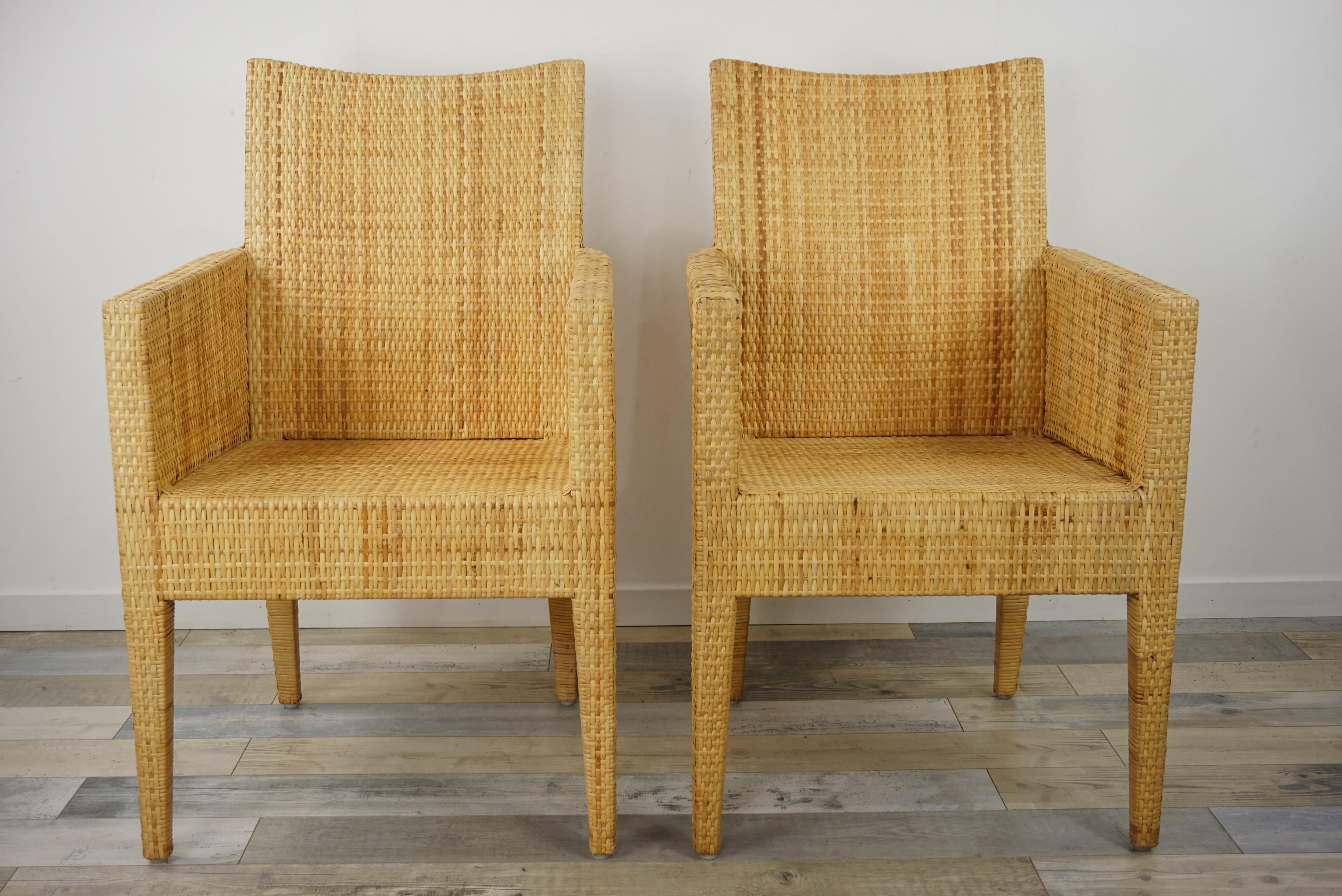 Sculptural bridge armchairs with a structure in solid wood covered with a braiding of natural rattan blade.