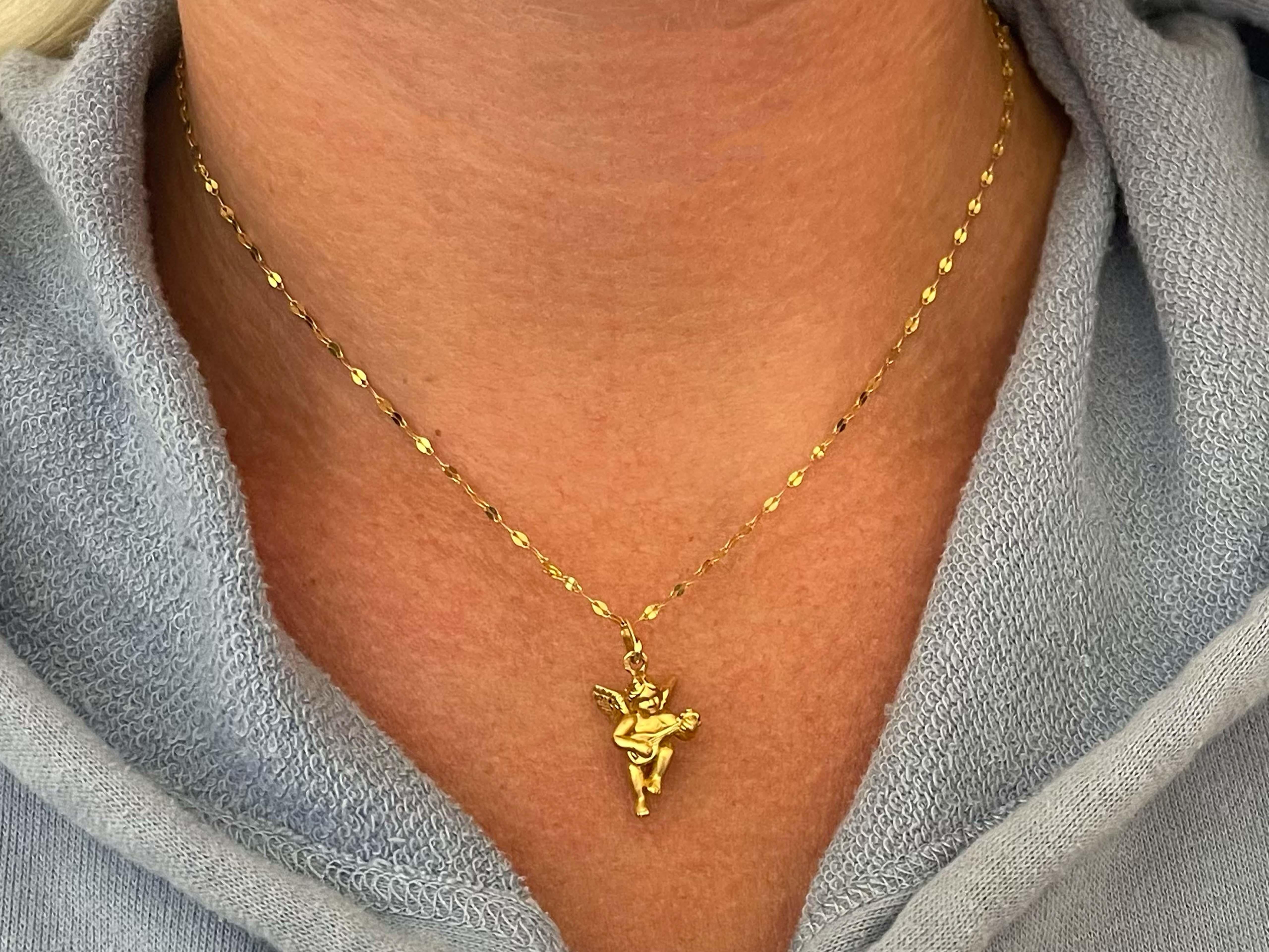 This pendant and chain is richly crafted in 18k yellow gold. The pendant measures 19 mm x 16 mm and comes on a 18 inch fancy link chain with a spring ring. The chain and pendant are stamped 