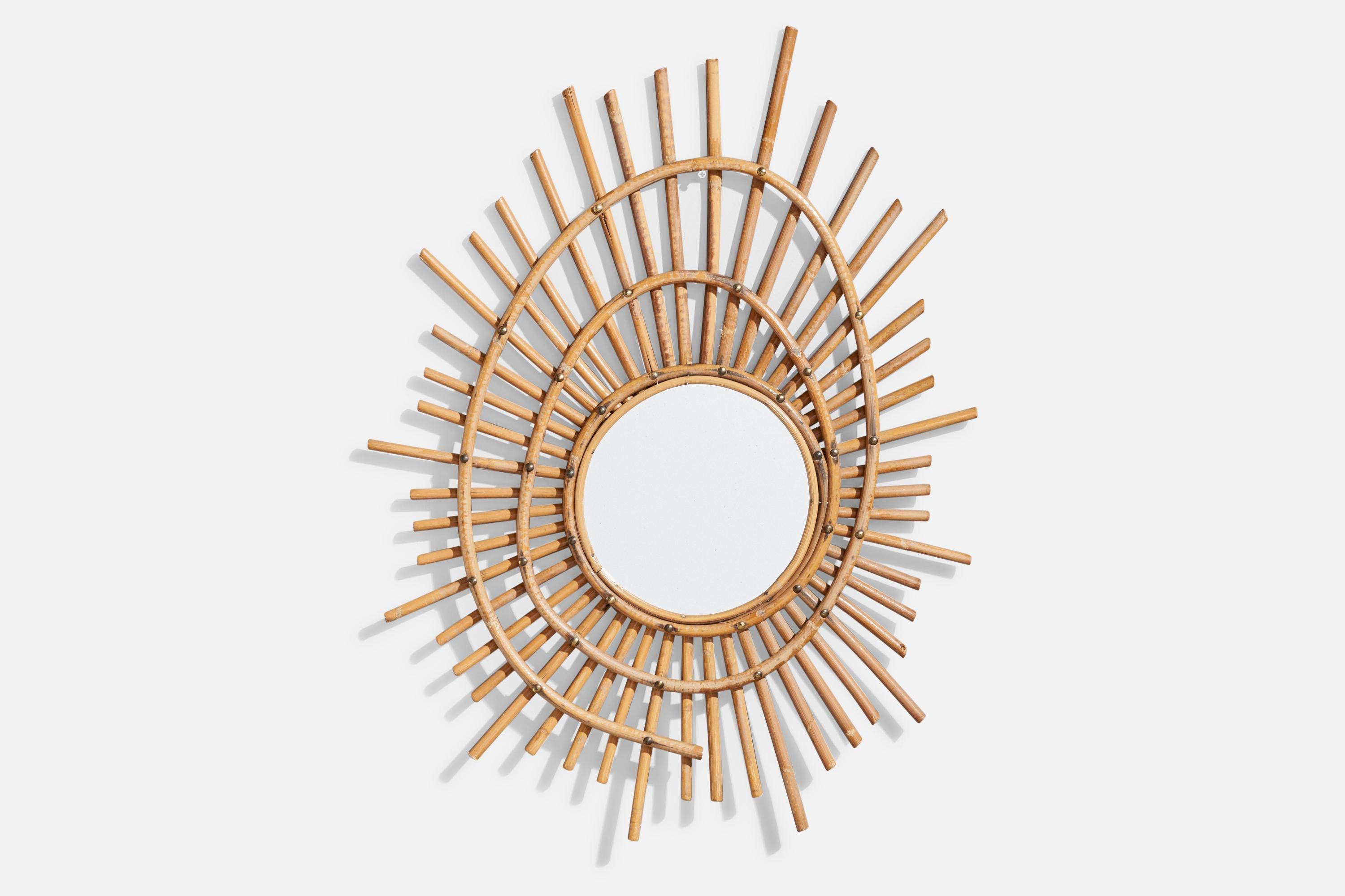 A freeform bamboo and brass wall mirror designed and produced in France, c. 1950s.

