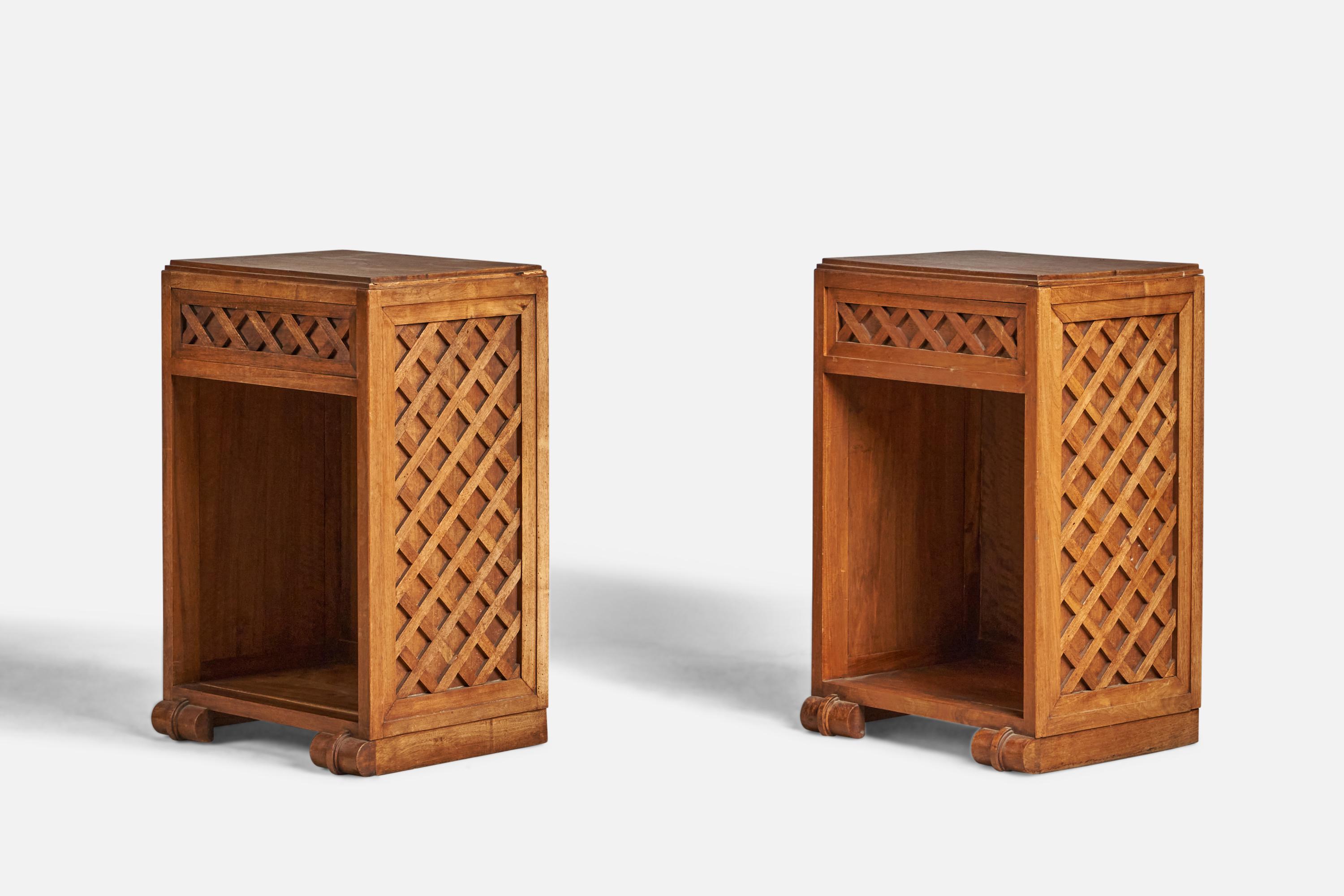 A pair of solid oak nightstands or bedside cabinets, designed and produced in France, c. 1940s.