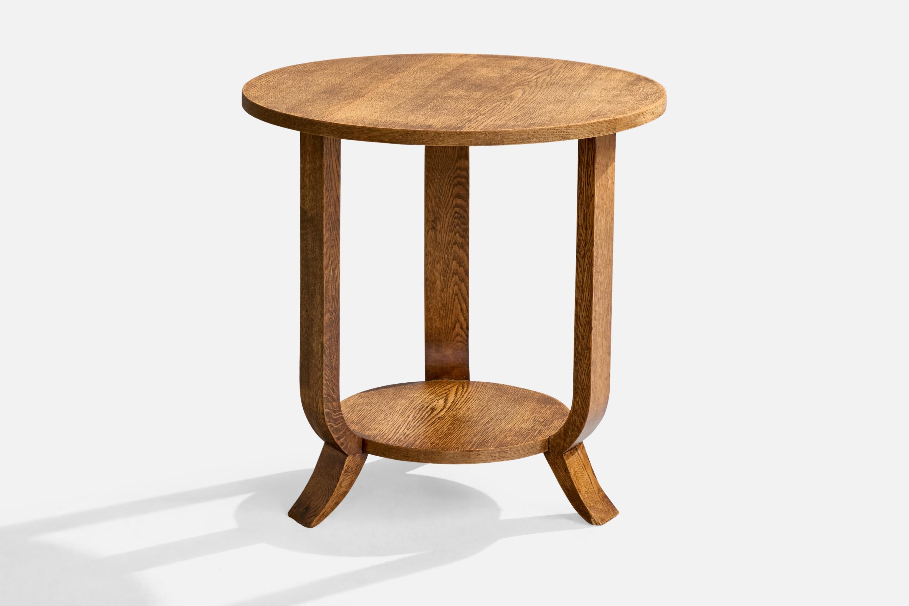 An oak side table or guéridon, designed and produced in France, c. 1930s.

Overall Dimensions (inches): 23.75