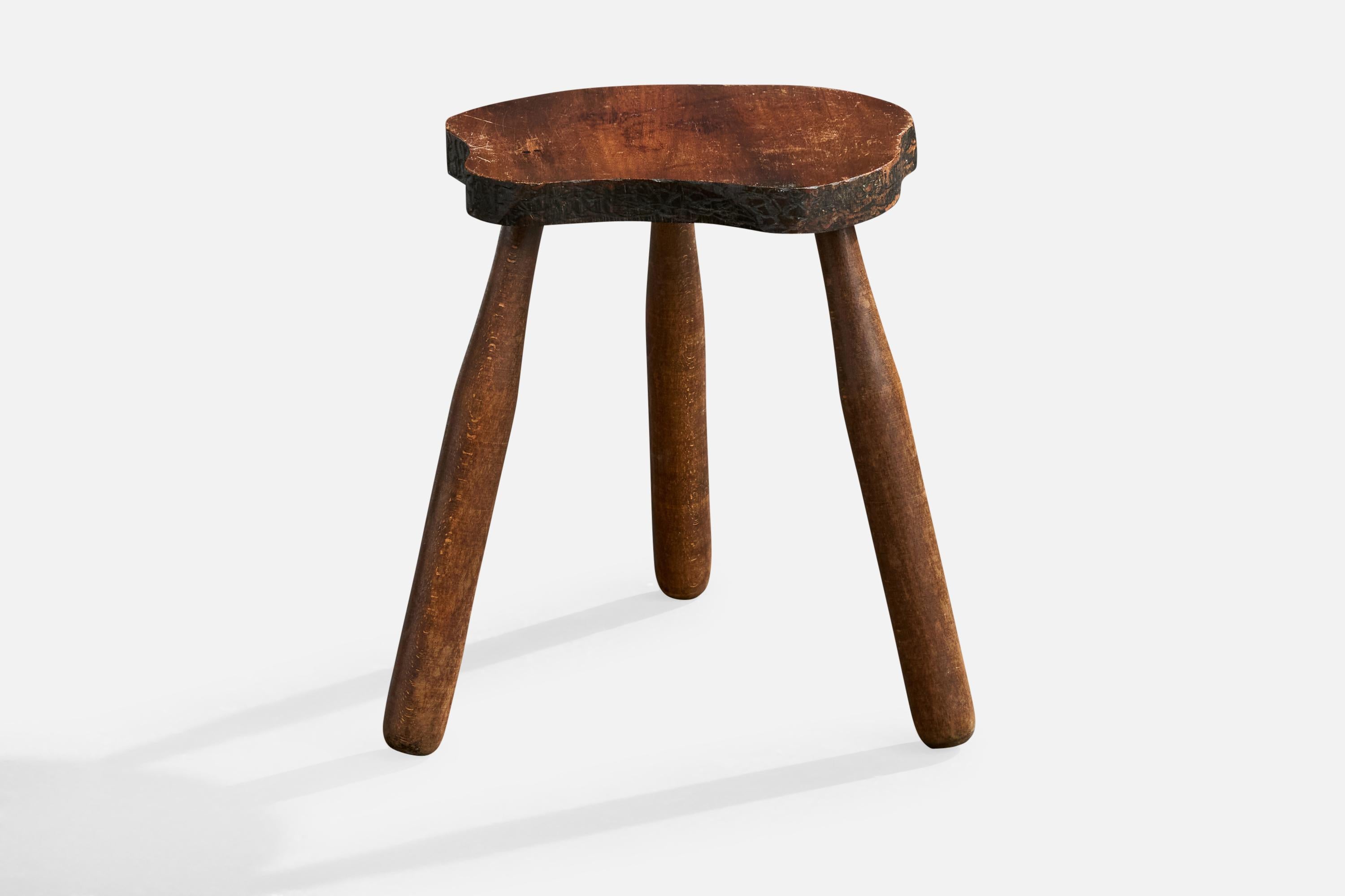 A dark-stained wood stool with hand-carved details, likely designed and produced in France, c. 1960s.

Overall Dimensions (inches): 14.5