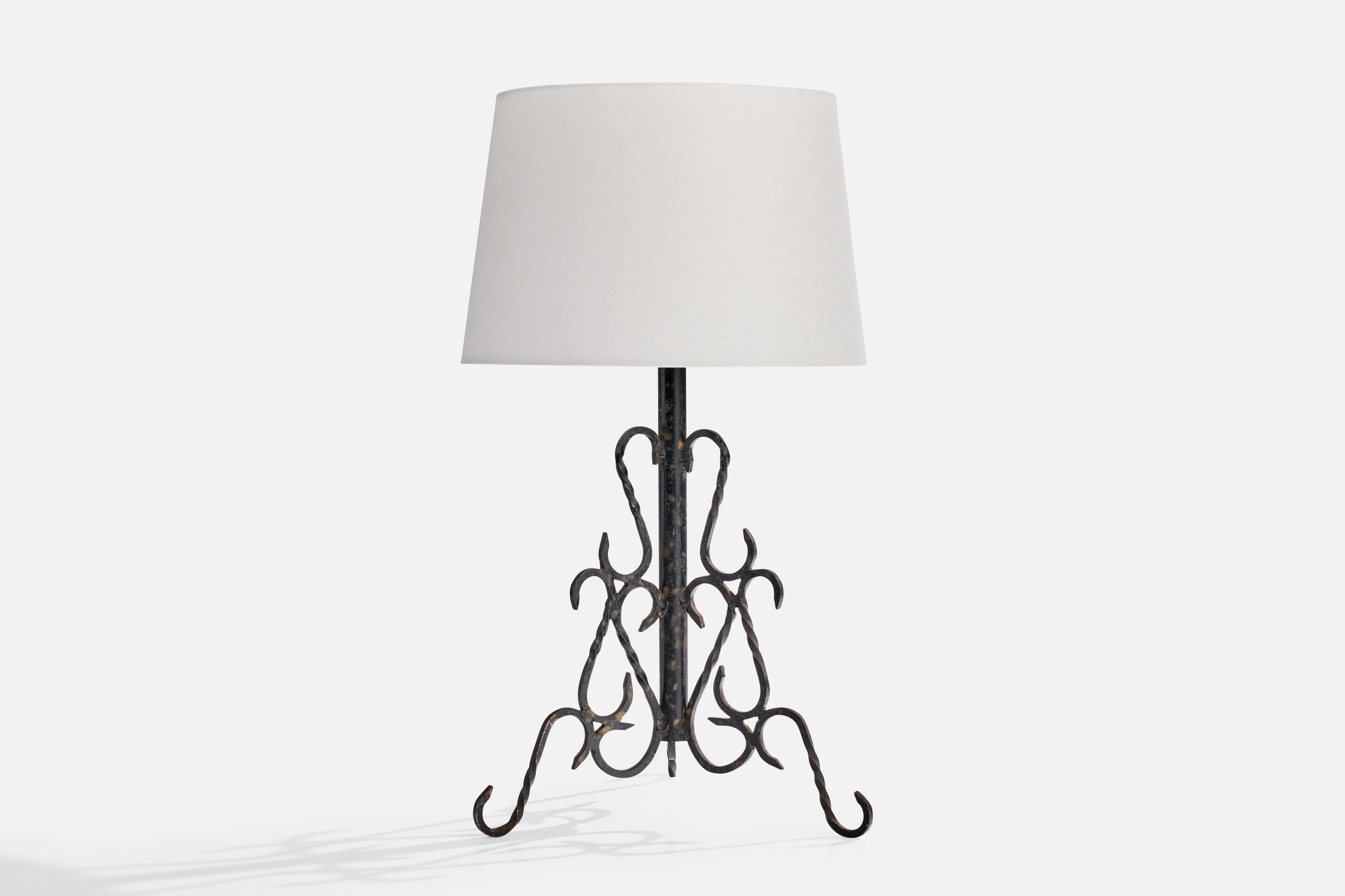 A black-lacquered iron table lamp designed and produced in France, c. 1950s.

Oxidation present to metal

Wear consistent with age and use

Dimensions of Shade (inches): 10.25” Top Diameter x 12.25” Bottom Diameter x 8” Height

Dimensions of Lamp