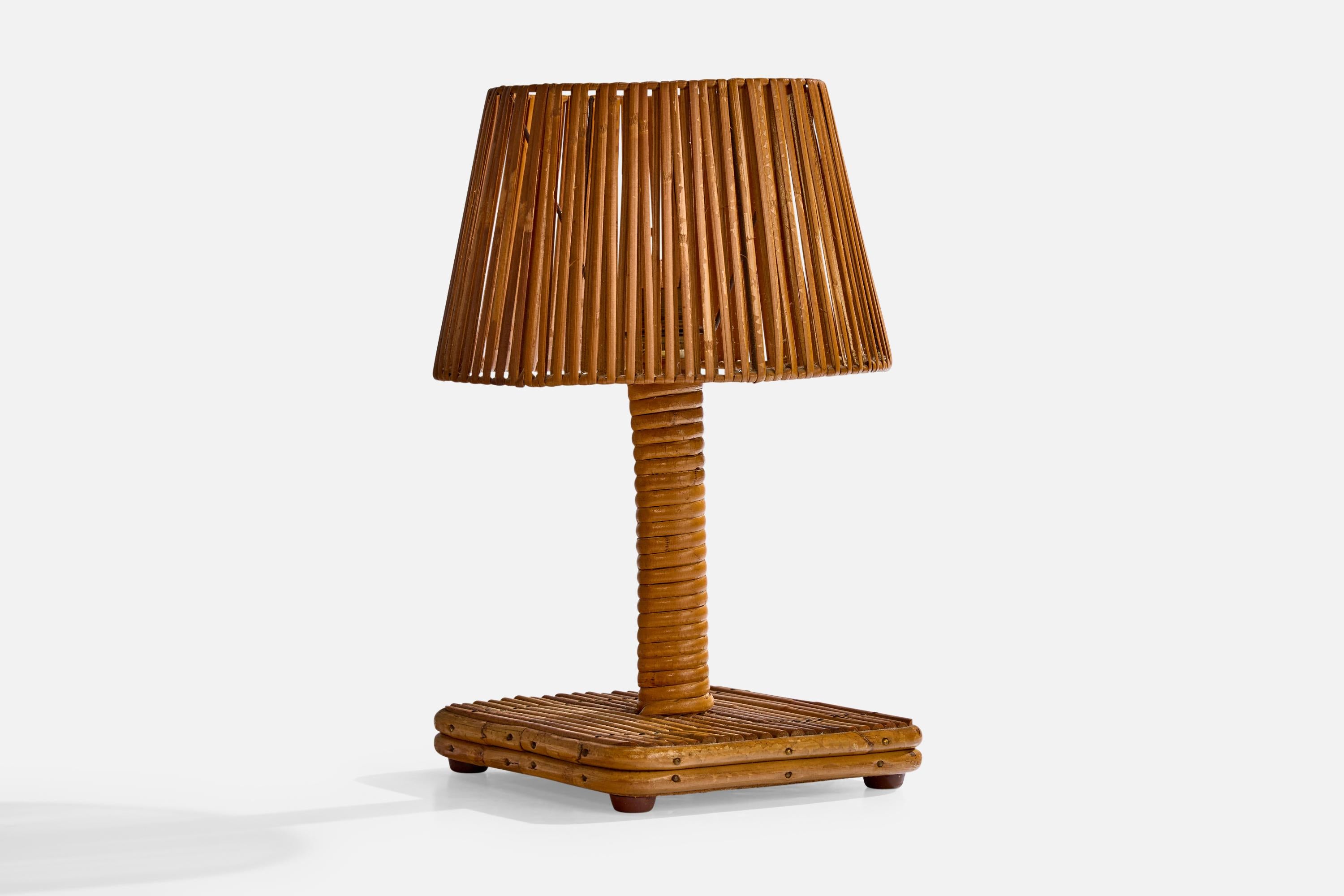 A rattan and wood table lamp designed and produced in France, c. 1970s.

Dimensions of Lamp with Shade (inches): 12.4