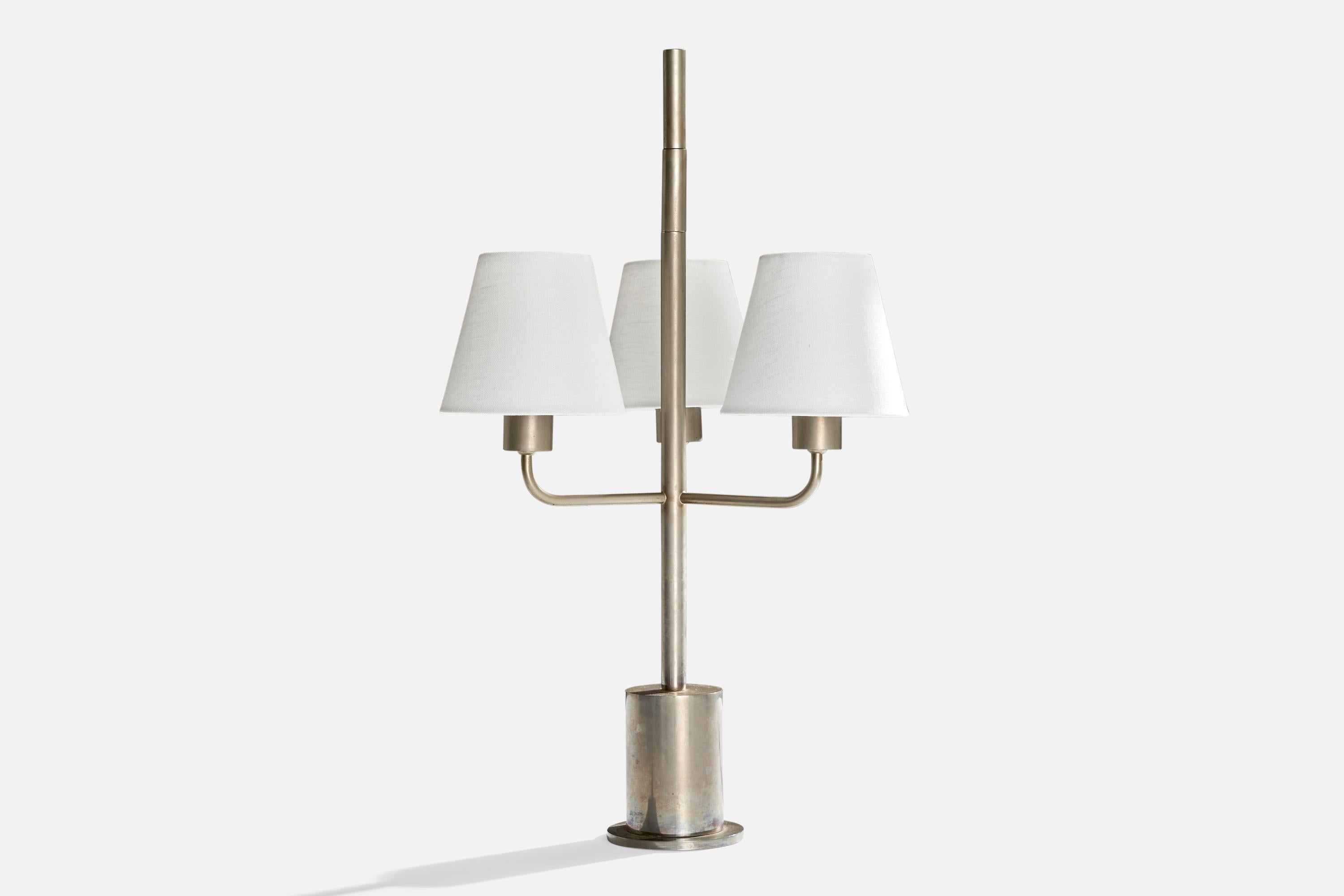A three-armed steel and white fabric table lamp designed and produced in France, c. 1970s.

Assorted lampshades. Center rod can screw of to accommodate finial indicating lamp likely originally had one larger lampshade mounted.

Dimensions of Lamp