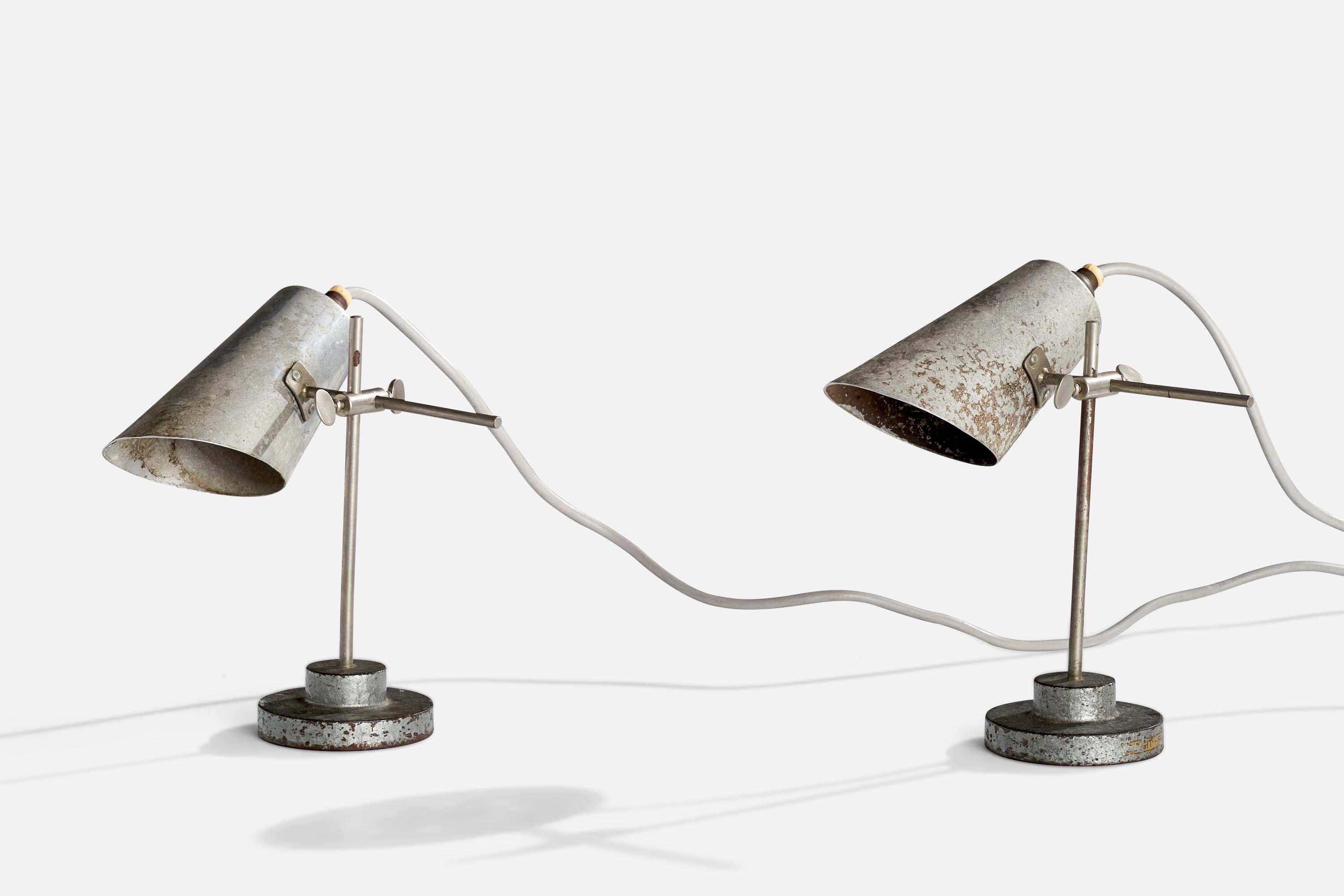 A pair of adjustable metal table lamps designed and produced in France, c. 1930s.

Dimensions of Lamp (inches): 8.25” H x 3.5”W  x 3.5” D
Dimensions of Shade (inches): 2.125” Top Diameter x 3.375” 
Bottom Diameter x 5.625