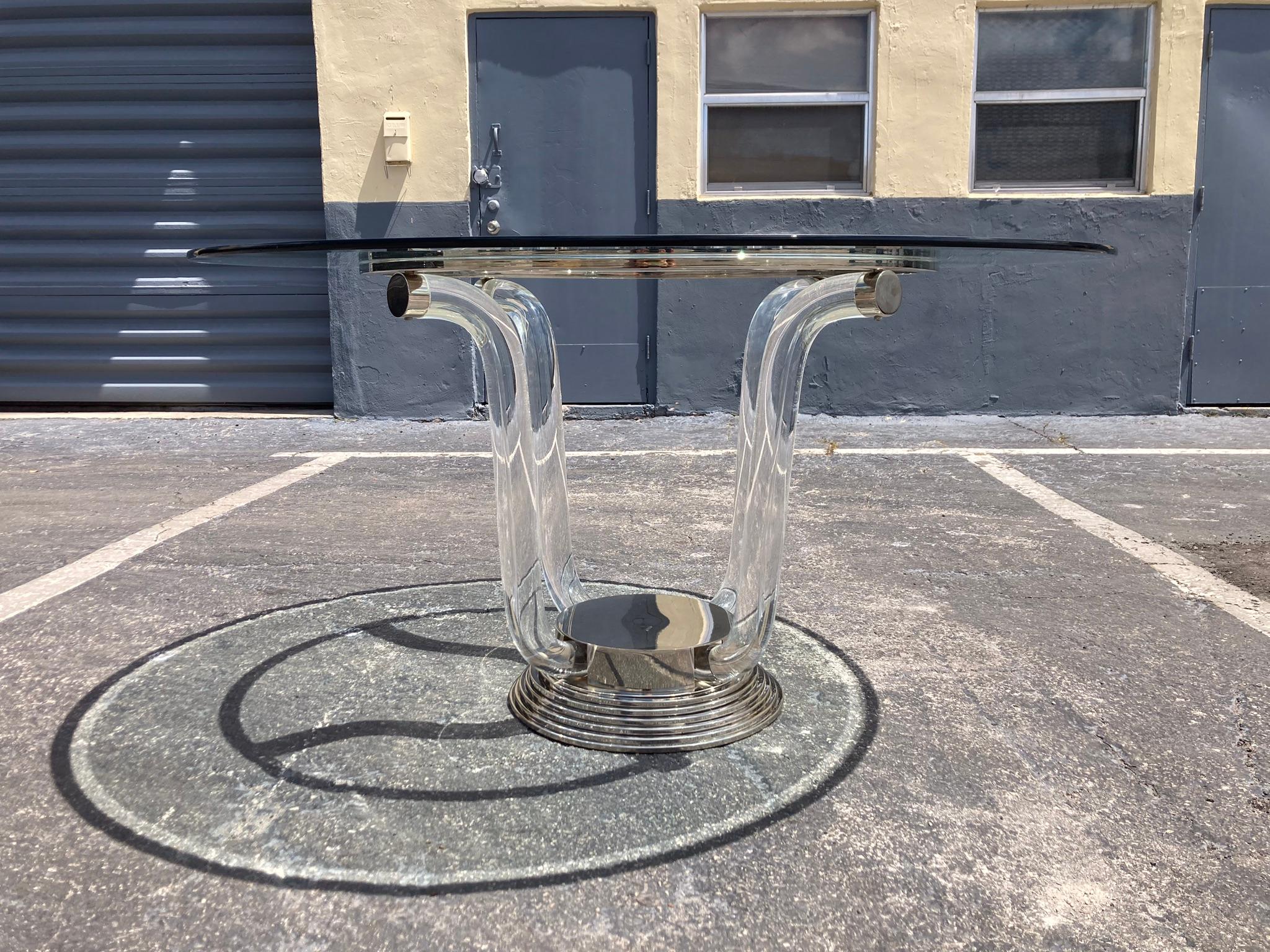Designer Table from the 70ies. Lucite with Stainless Steel and Nickel plated metal. According to the previous owner bought in France.
The measurements of the base without glass are 35.5” in diameter and 28.75 high.