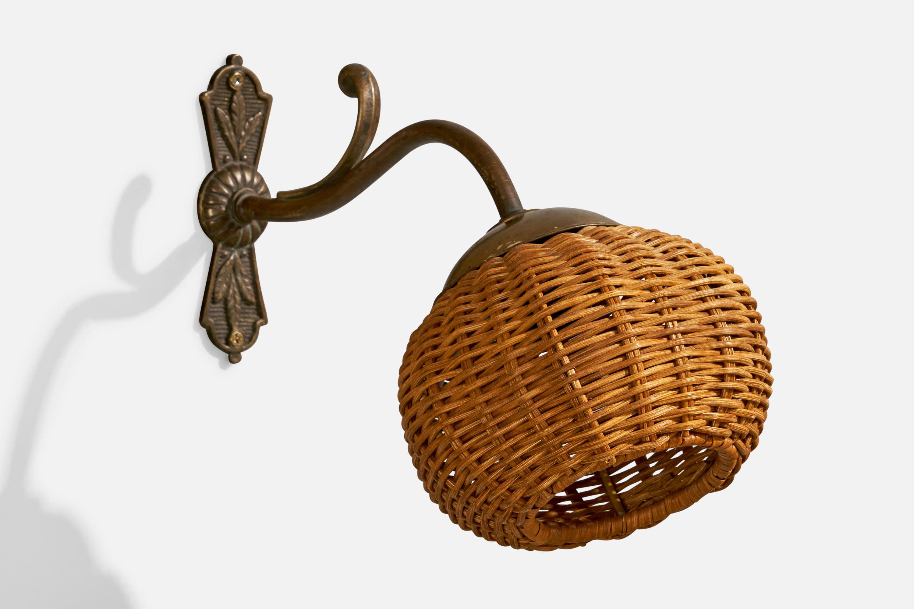A brass and rattan wall light designed and produced in France, c. 1940s.

Overall Dimensions (inches):  8” H x  5.5” W x  11” D

Back Plate Dimensions (Inches):  5” H x 1.375” W x .5” D

Bulb Specifications: E-12

Number of Sockets (per fixture):