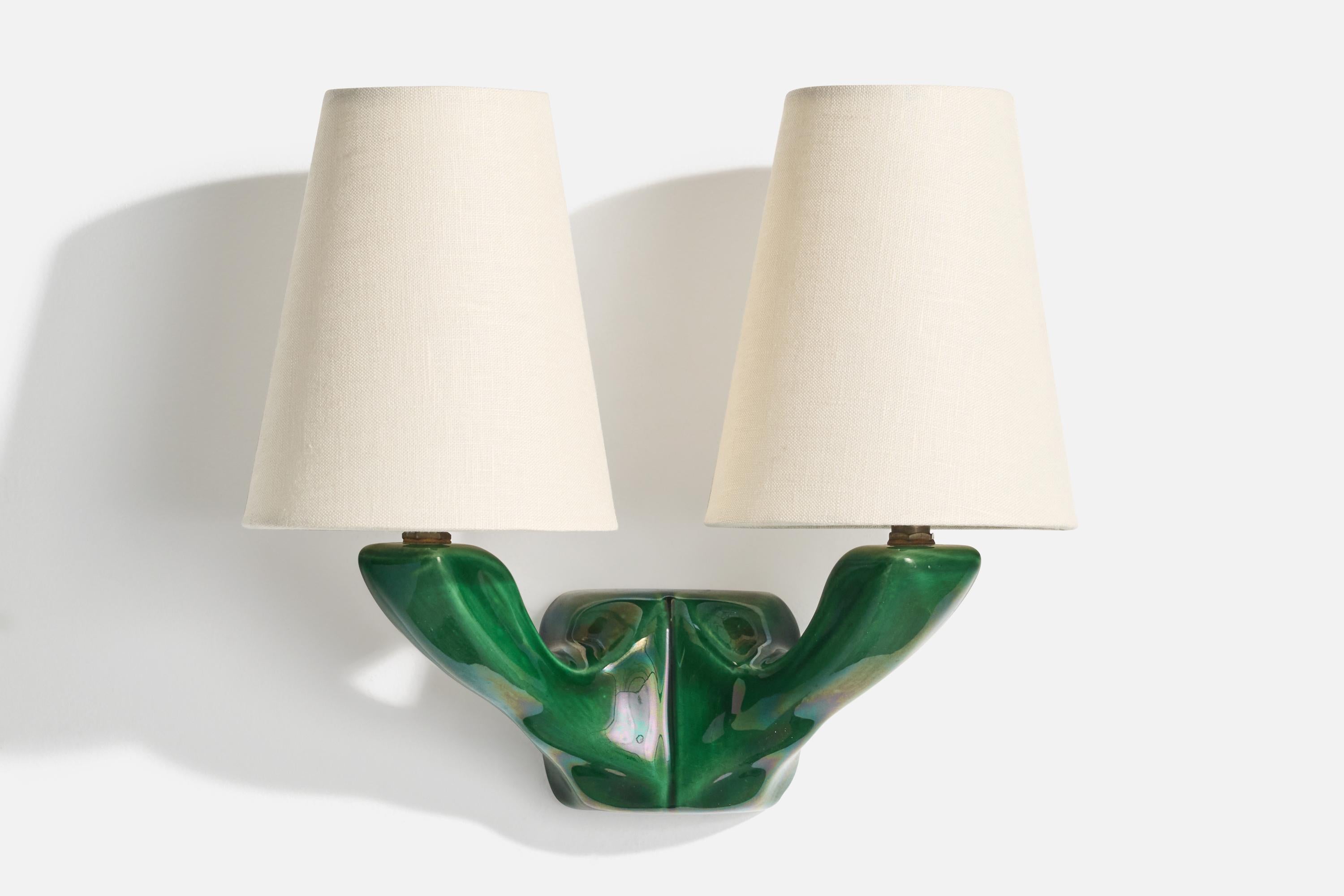 A green-glazed ceramic, brass and white fabric wall light designed and produced in France, c. 1950s.

Overall Dimensions (Inches): 11” H x 12” W x 6.25“ D

Back Plate Dimensions (Inches): 3.125” H x 3.5“ W 

Bulb Specifications: Bayonet

Number of