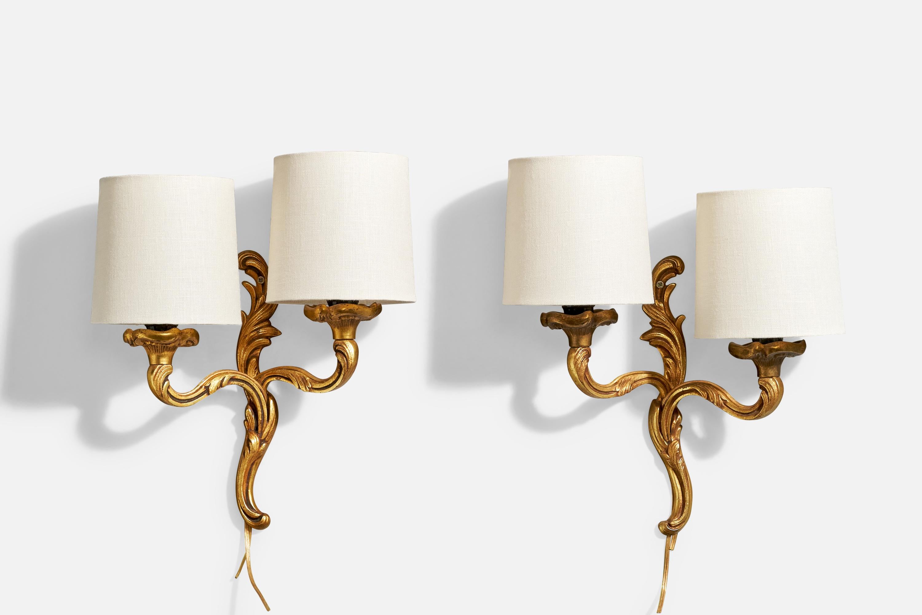 A pair of brass and fabric wall lights designed and produced in France, c. 1950s.

Overall Dimensions (Inches): 12” H x 10” W x 4.875“ D

Back Plate Dimensions (Inches): 8.75” H x 1” W x .5” D

Bulb Specifications: E-12

Number of Sockets (per