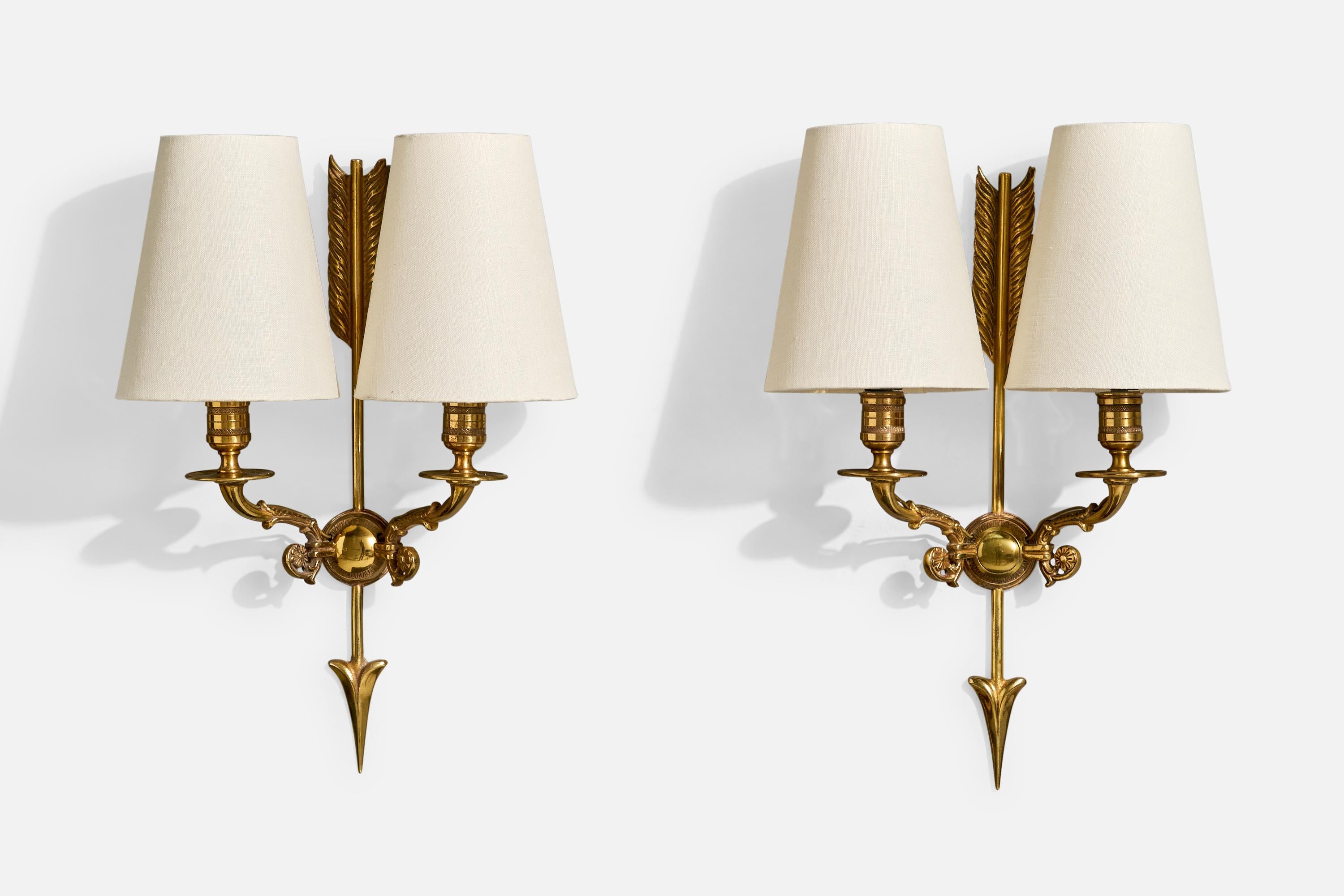 A pair of brass and white fabric wall lights designed and produced in France, c. 1950s.

Overall Dimensions (Inches): 15.5” H x 10.5” W x 5.5“ D

Back Plate Dimensions (Inches): 1.875” H x 1.875” W x .5” D

Bulb Specifications: E-12

Number of