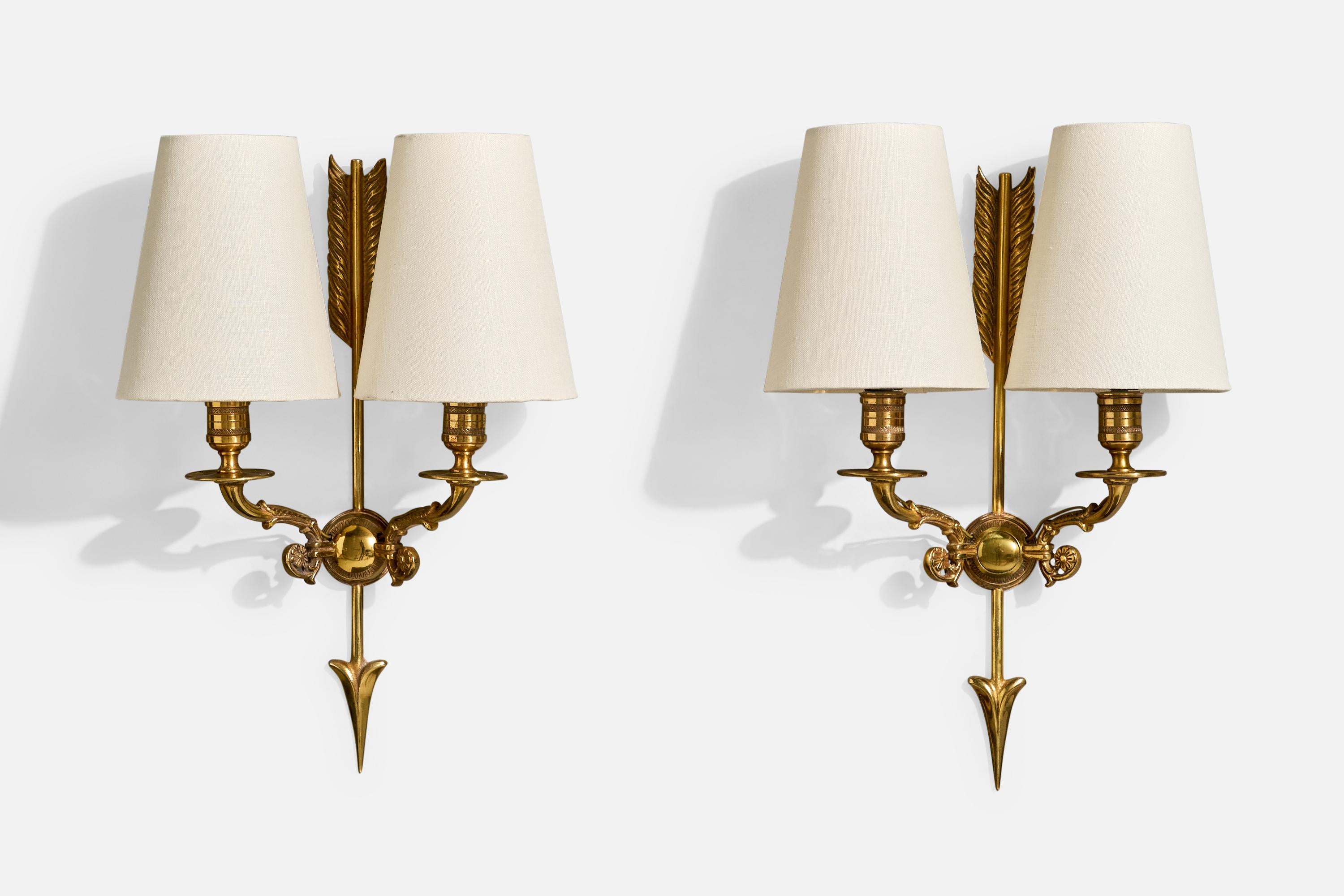 Coppia di applique in ottone e tessuto bianco progettate e prodotte in Francia, anni '1950 circa.

I bracci in ottone presentano una moderata ossidazione. 

Dimensioni complessive (pollici): 15,5