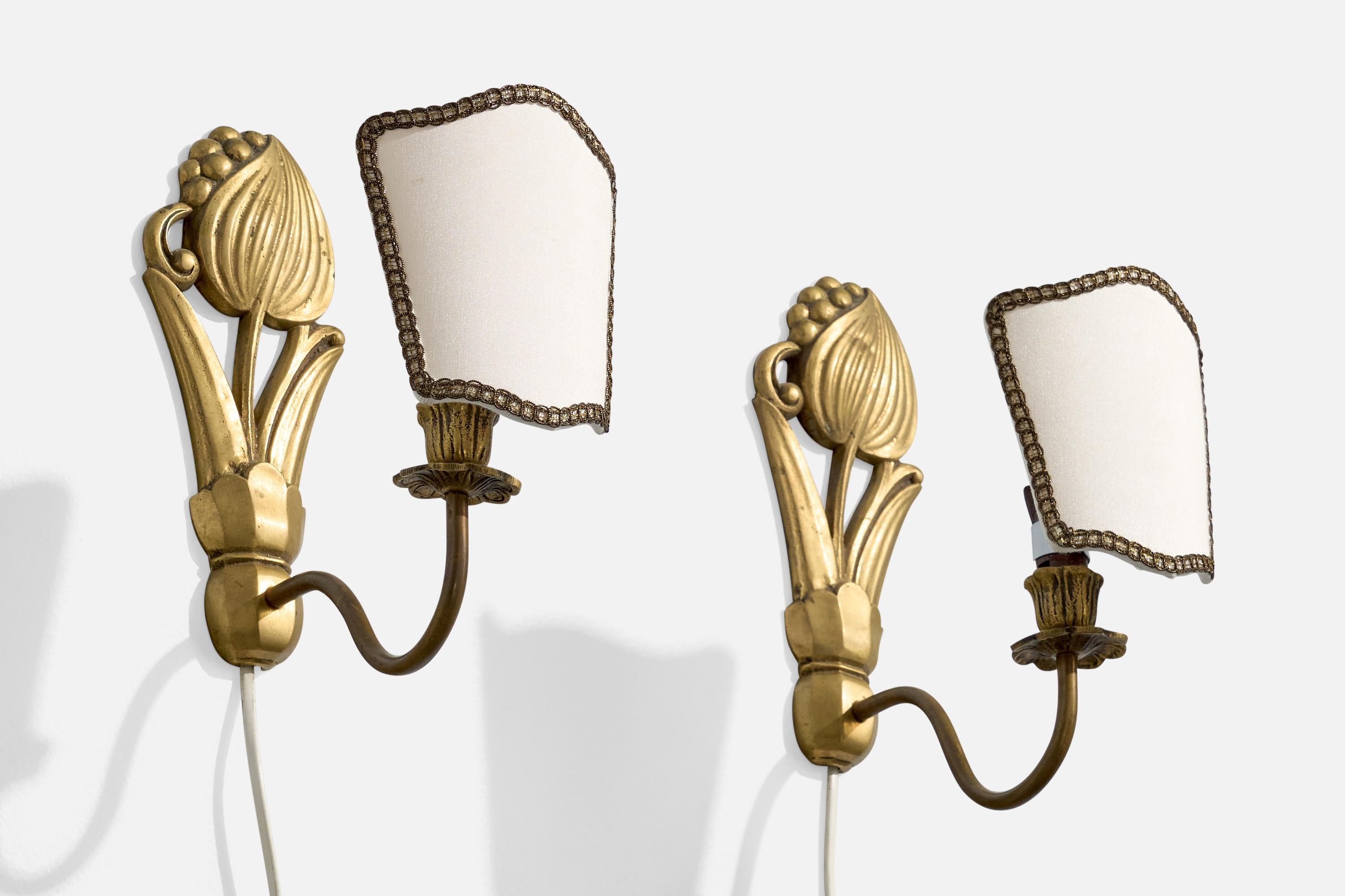 A pair of brass and white fabric wall lights designed and produced in France, c. 1950s.

Light oxidation present throughout the brass fixtures.

Overall Dimensions (Inches): 10” H x 4.4” W x 8” D

Back Plate Dimensions (Inches): 8.375” H x 3.5“ W x