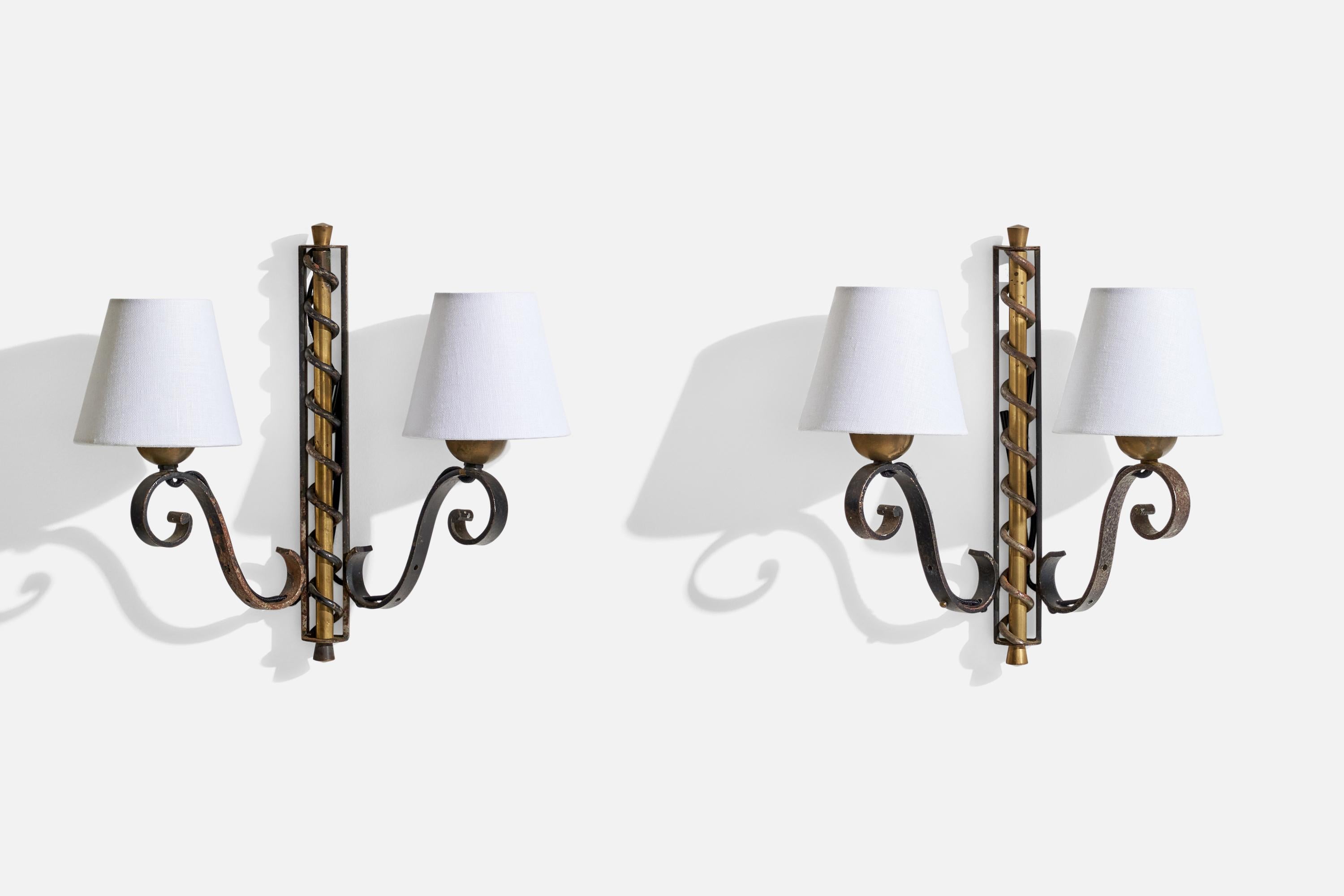 A pair of brass, iron and white fabric wall lights designed and produced in France, c. 1940s.

Overall Dimensions (inches): 13.5” H x 14.5” W x 5.25” D
Back Plate Dimensions (inches): N/A
Bulb Specifications: E-12 Bulb
Number of Sockets: 4

All