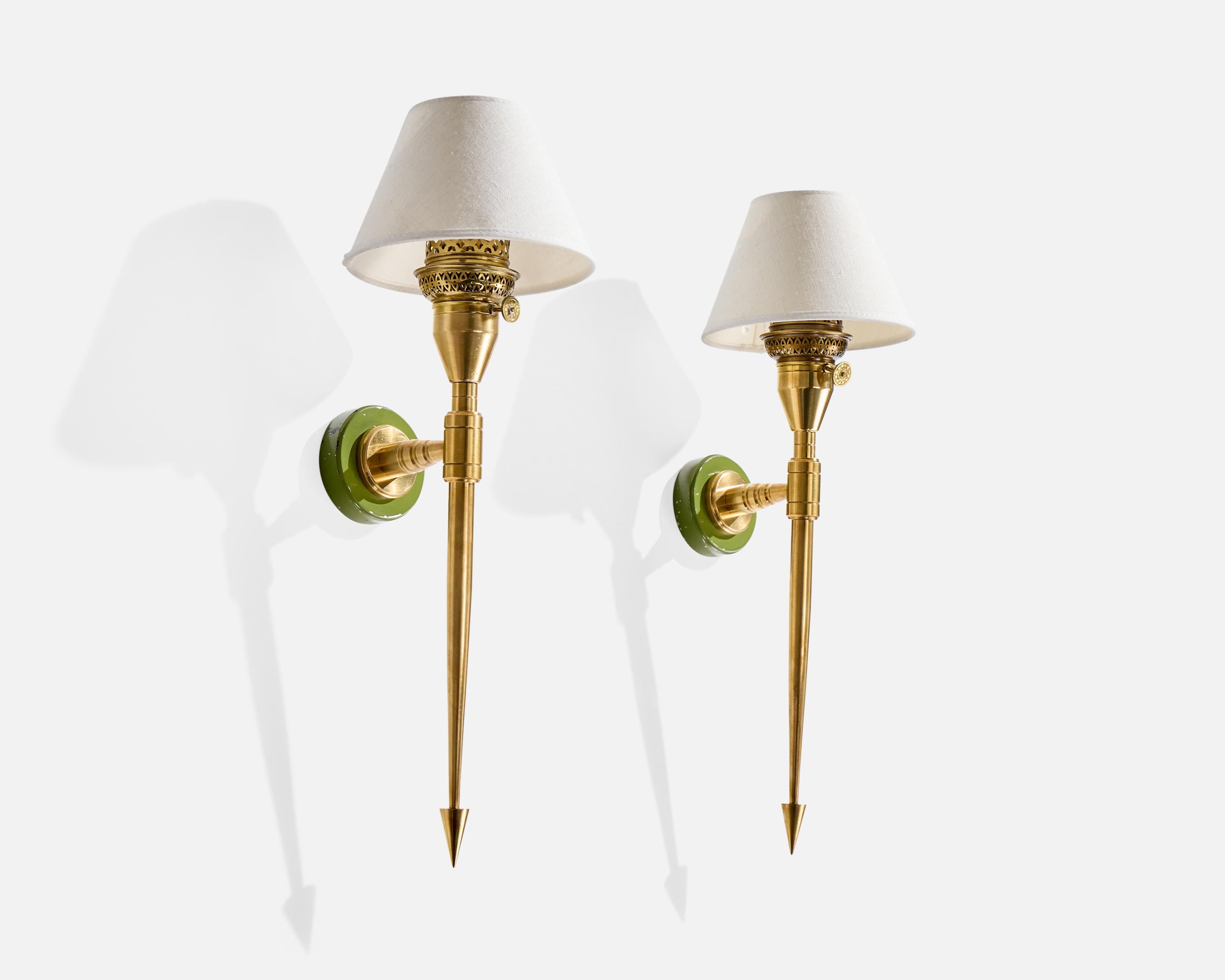 A pair of brass, green-lacquered metal and white fabric wall lights designed and produced in France, c. 1950s.

Oxidation present to brass

Loss of green lacquer present to metal backplate

Wear consistent with age and use

Overall Dimensions