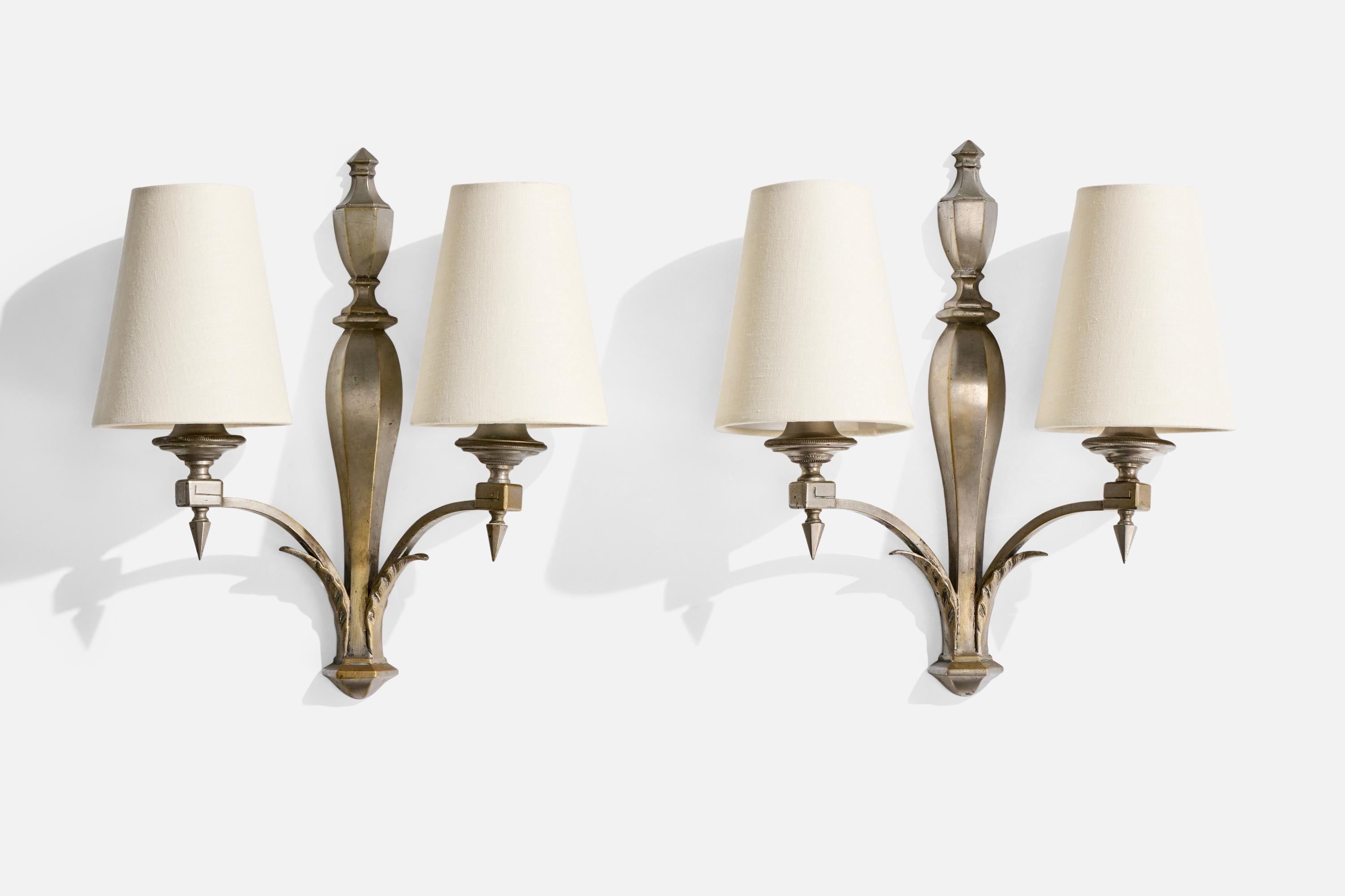 A pair of metal and white fabric wall lights likely designed and produced in France, c. 1940s.

Overall Dimensions (Inches): 14.375” H x 12.25” W x 5.25“ D

Back Plate Dimensions (Inches): 14.375” H x 2“ W x .75” D

Bulb Specifications: E-12

Number
