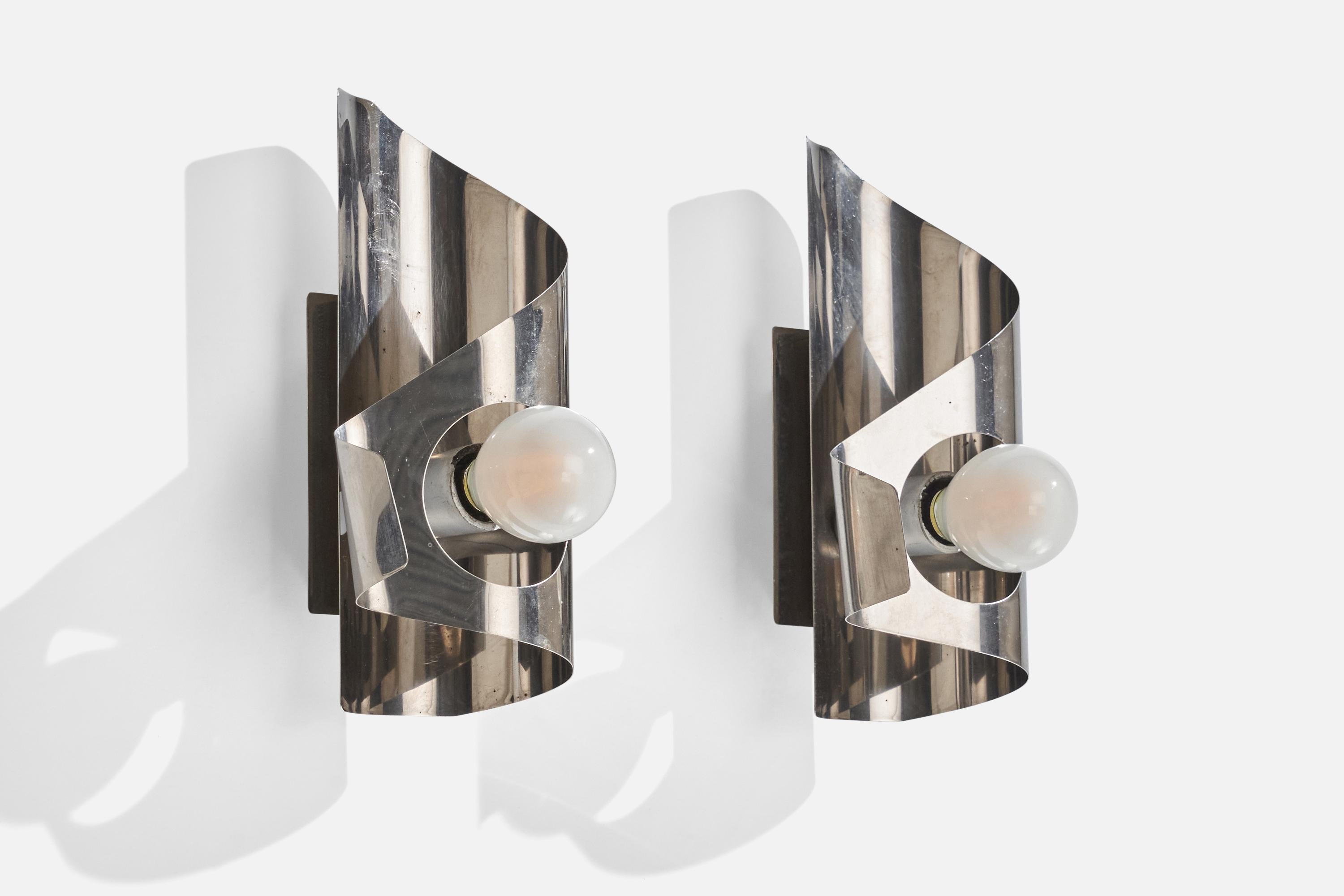 A pair of metal wall lights designed and produced in France, c. 1970s.

Overall Dimensions (inches): 8.25” H x 3.88” W x 2.81” D
Back Plate Dimensions (inches): 4.25” H x 2.75” W x 0.83” D
Bulb Specifications: E-14 Bulb
Number of Sockets (per