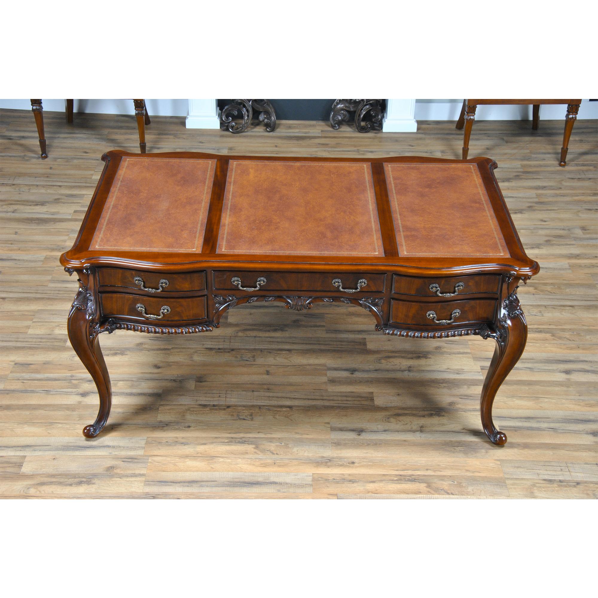 This Chippendale style Mahogany and Leather French Desk is produced by Niagara Furniture. A high quality writing desk that sets the standard for beauty and function among antique reproductions. Constructed from the finest grained mahogany the top