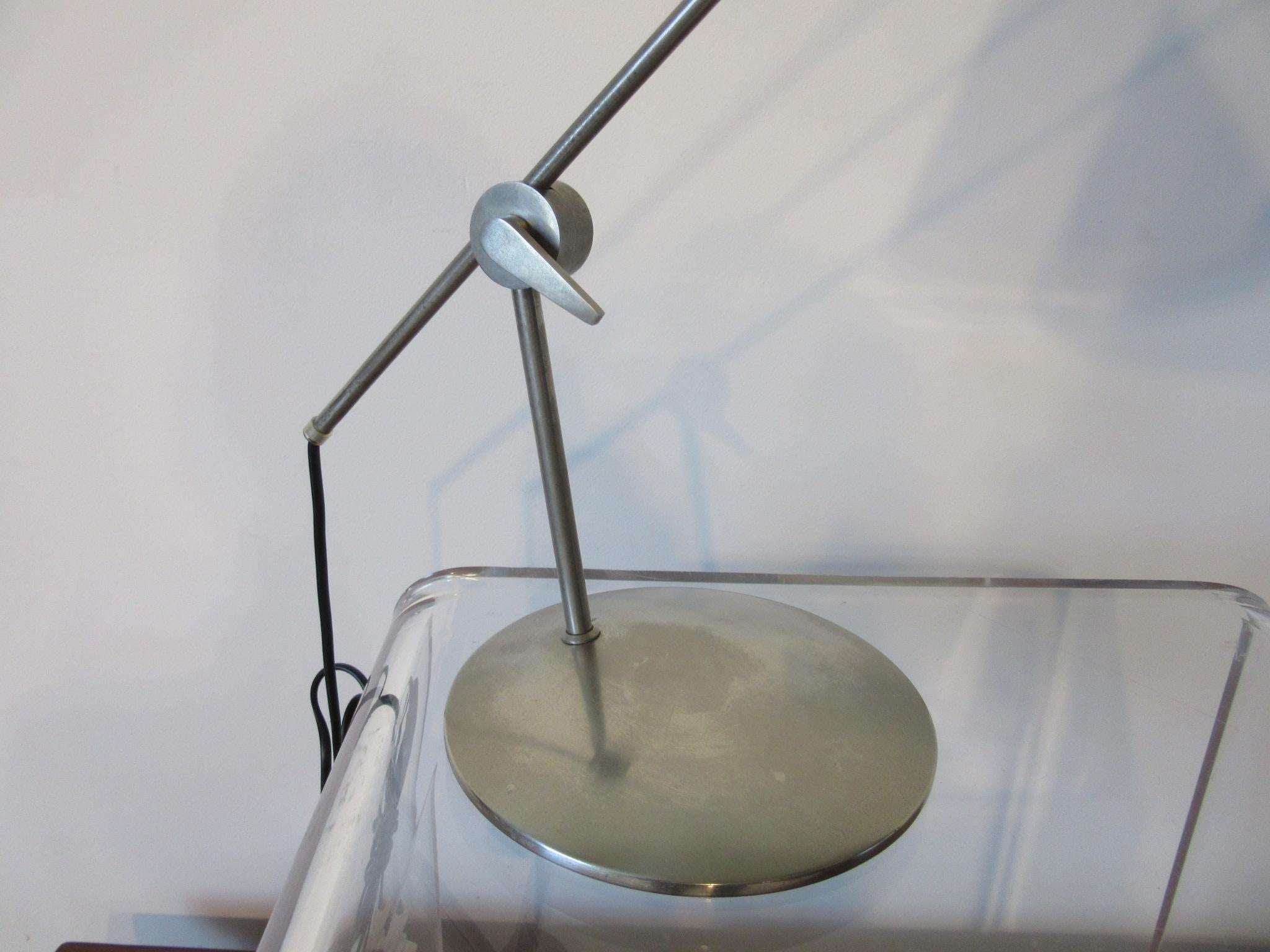 A hard to find steel and nickel plated desk lamp with adjustable arm , push button switch and satin black metal cone shade that swivels , a well crafted lamp made in Denmark and designed by Th . Valentiner  . The dia. of the shade is 9
