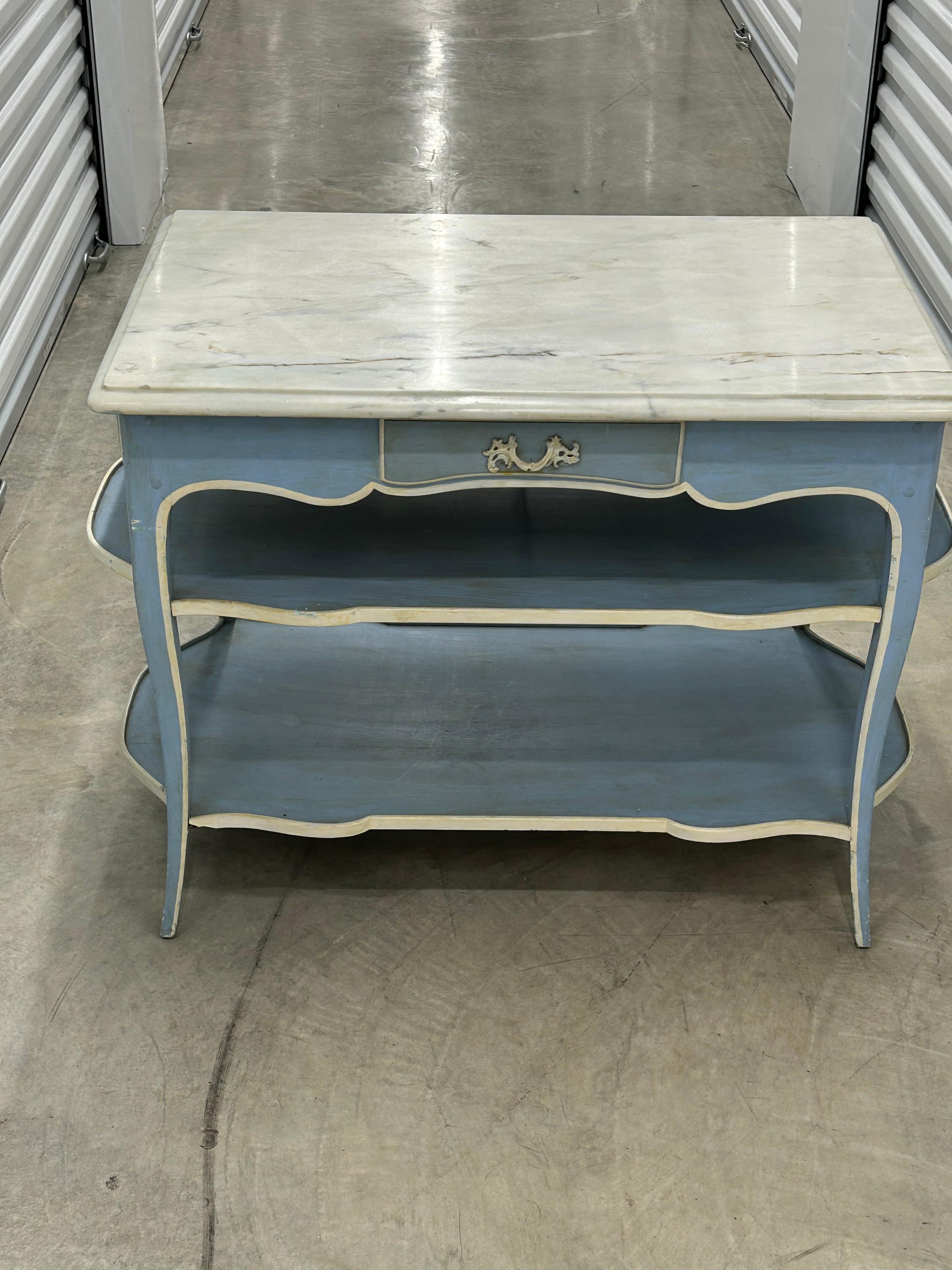 Unique hand painted marble top dessert table with two lower shelves ,three drawers i and one false drawer .very stylish form and proportions.. exceptional, construction and solid… on slender cabriole legs ,painted in the soft French blue and white…