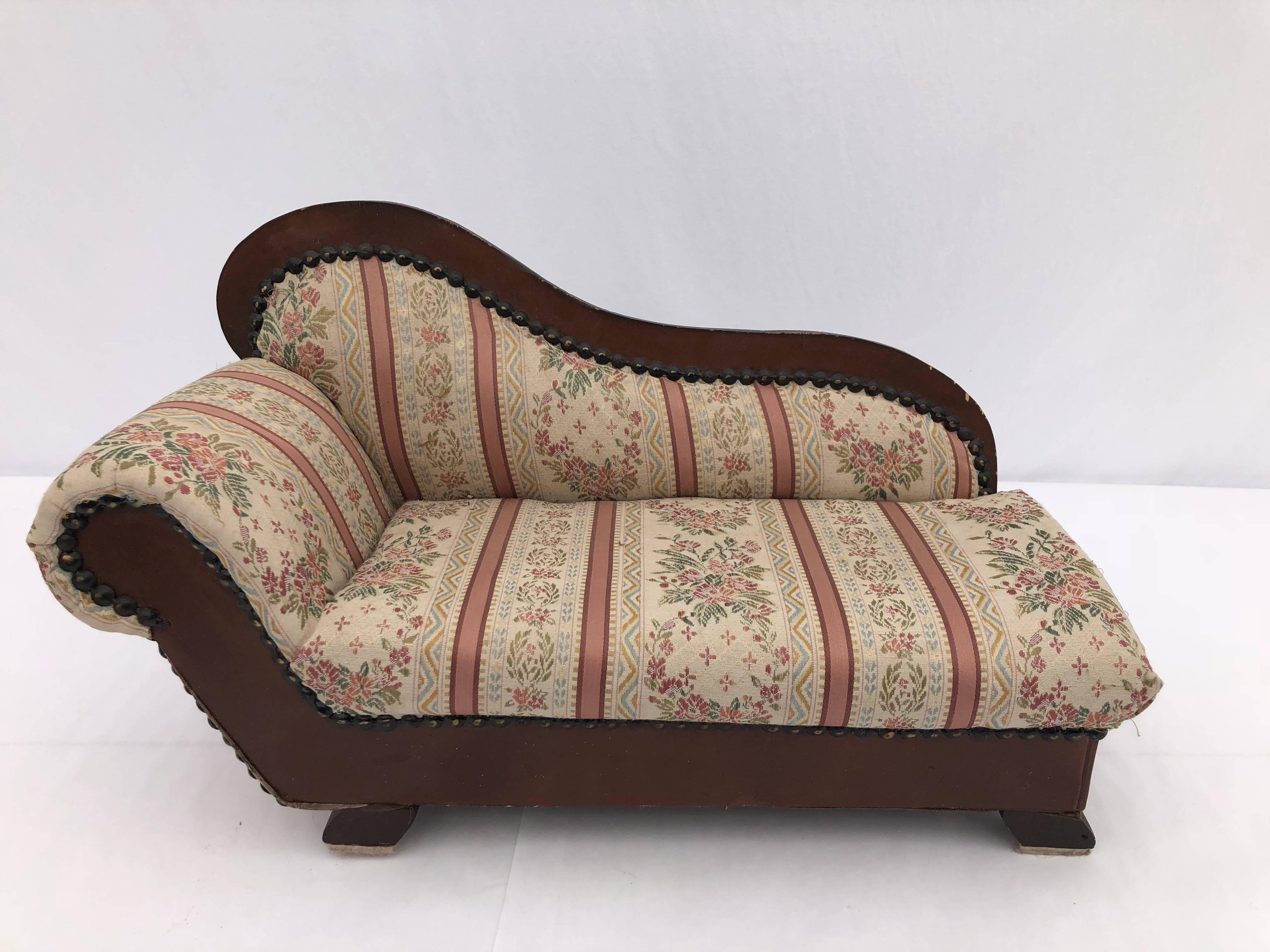 This is a lovely French doll sofa with great detail. It is in wood with beautiful silk fabric and fabric tacks.