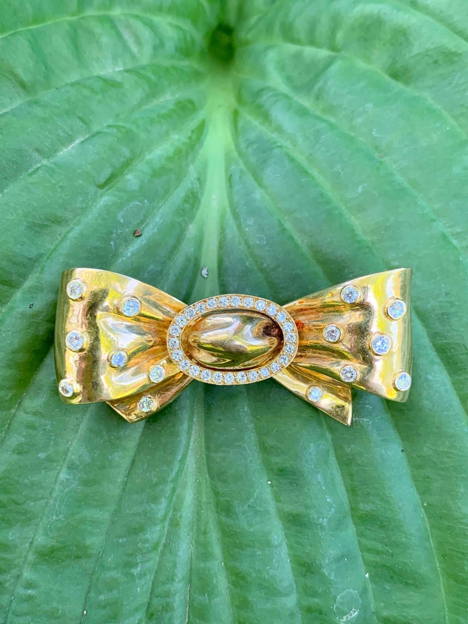 This beautiful ladies, vintage, 18k gold fur clip, features a ribbon bow design, which is ornamented with 40 diamonds!! 40 Diamonds!!!  The pin mechanism works perfectly on this piece
It is stamped 18k with a French hallmark.
There are 14 bezel set