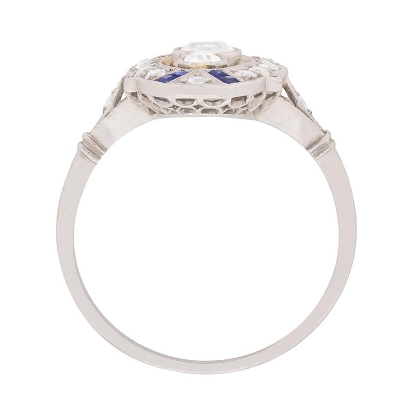 Straight out of 1920s France, an original Art Deco diamond and sapphire dinner ring!

An elegant combination of diamonds and sapphires set in millegrained platinum frames three graduated old cut diamonds set horizontally at the ring’s centre.

The