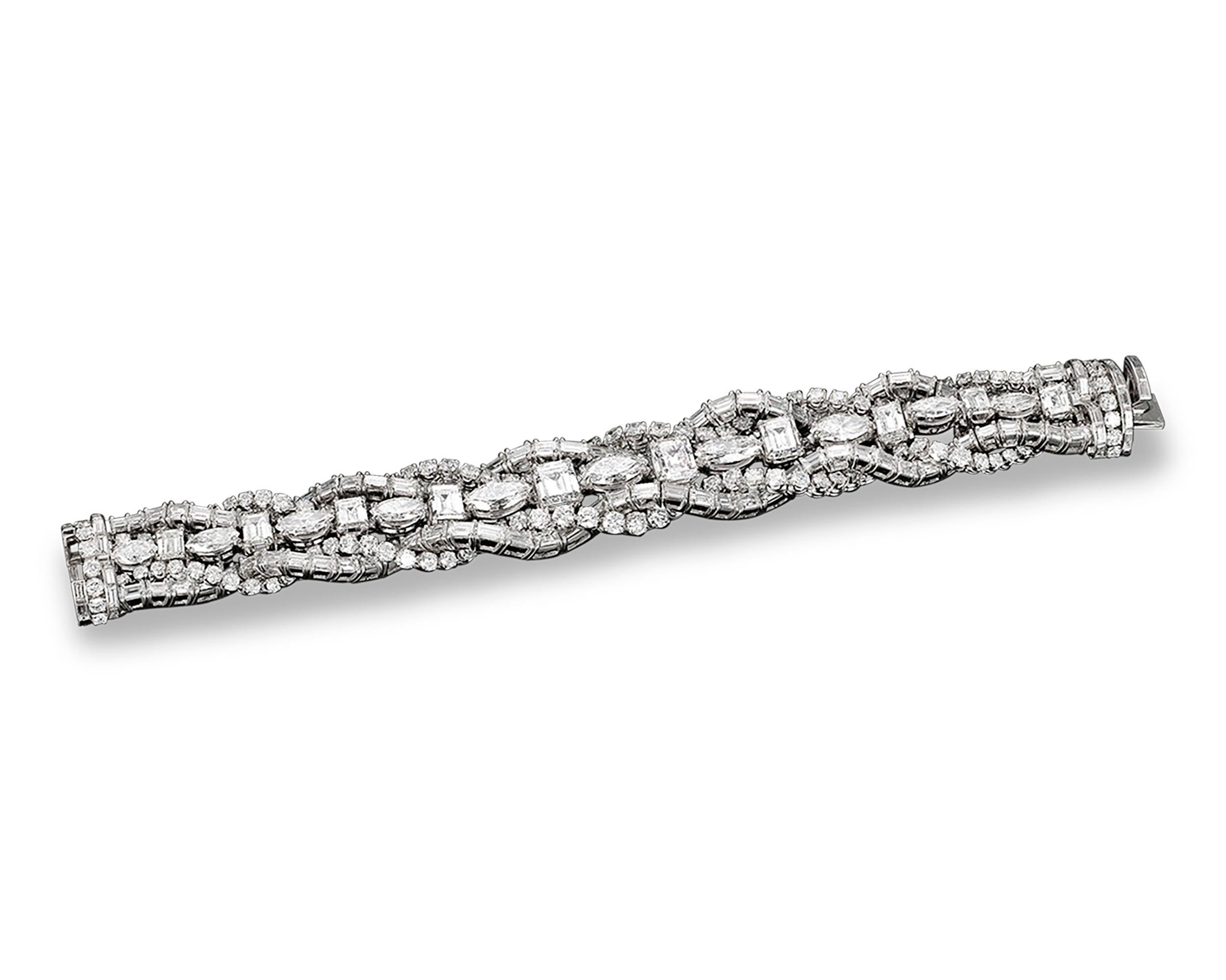 This impeccable French bracelet showcases a stunning collection of pure white diamonds. The largest five of these superb stones, weighing 9.19 total carats, are all certified by the GIA as D color. Boasting approximately 55.00 carats of diamonds in