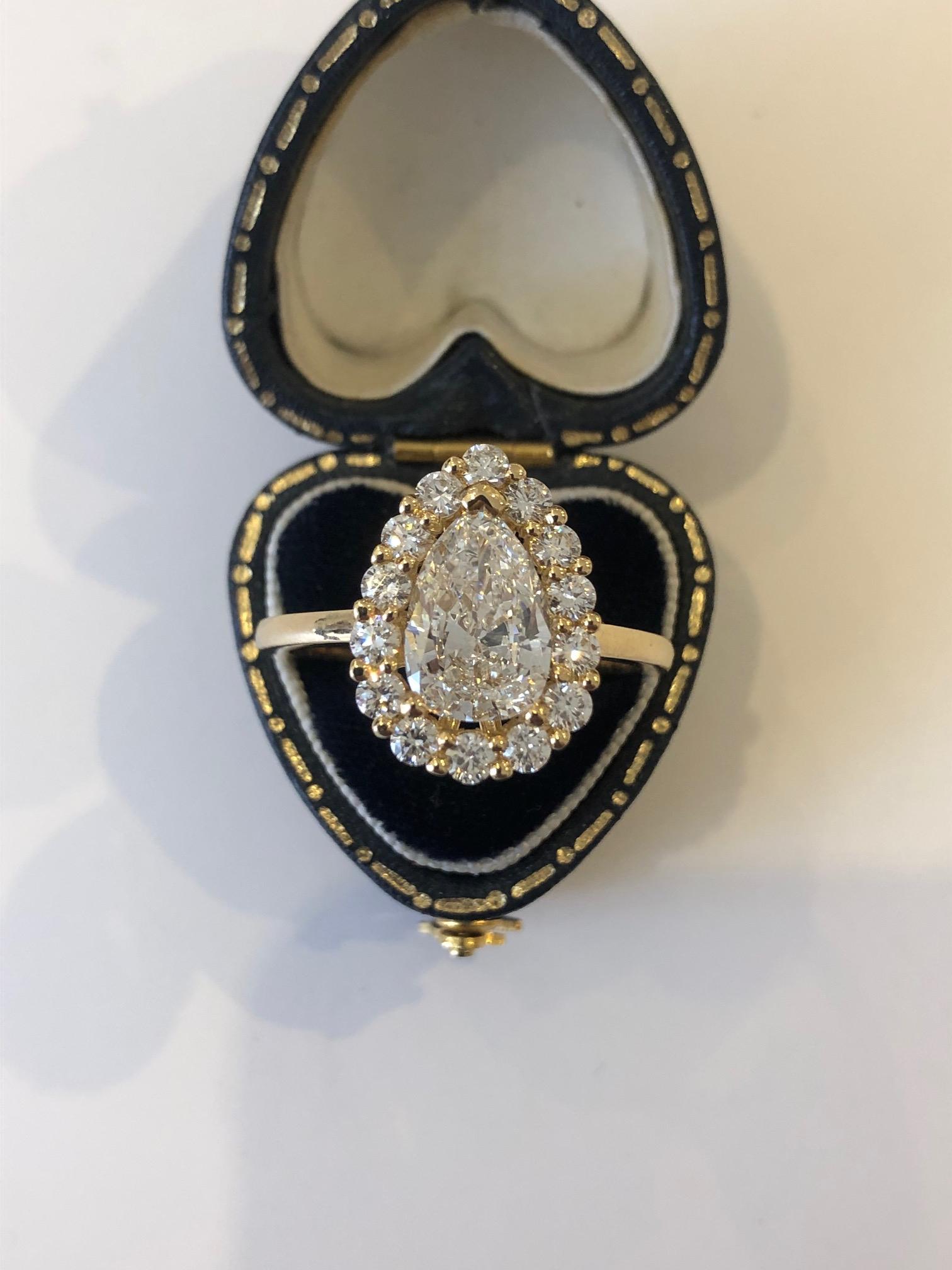 French Diamond Cluster Ring with a 2.01 carat Pear Shape Diamond Certified GIA 
A French diamond cluster ring set in hallmarked 18ct yellow gold. The ring centres a 2.01 carat pear shaped diamond graded by the GIA as G colour and VS1 clarity.
The