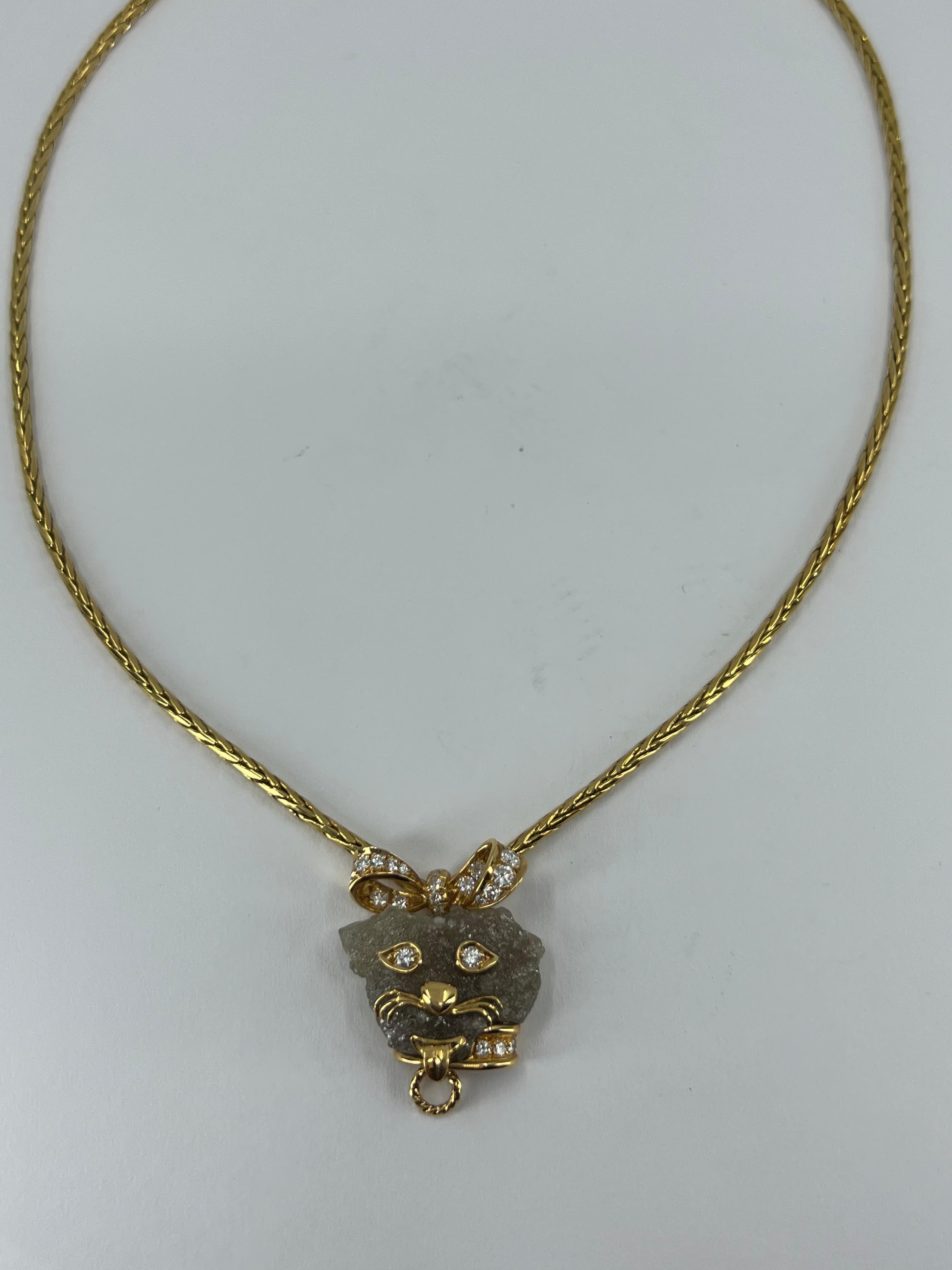 A cute and fun French 18k gold necklace with a dog’s head pendant.

This unique piece carries multiple tiny details that are interesting to explore. The necklace consists of the gold foxtail chain and the diamond pendant designed as a stylized dog’s